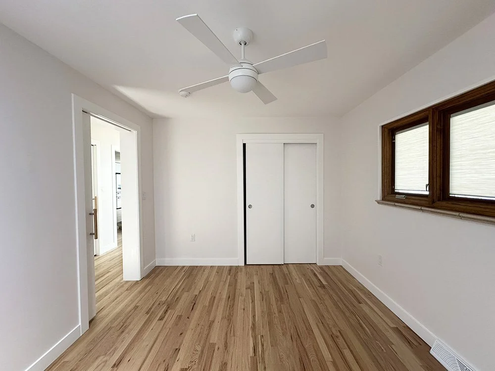 The smallest bedroom has only one door, which leads to the hallway through a pocket door.