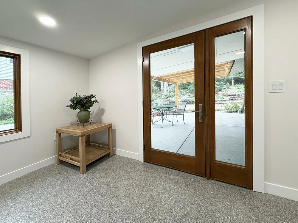 A wide, no threshold door leads directly from the laundry room to the back patio and pergola.