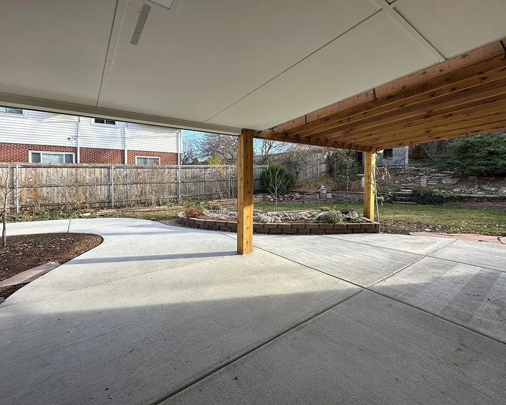 View of the rear patio with partial pergola and partial roof. 