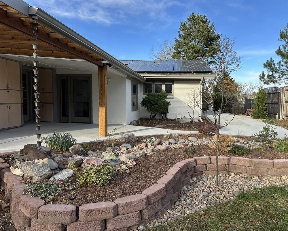 A raised planter partially watered by rainwater frames the rear patio. 