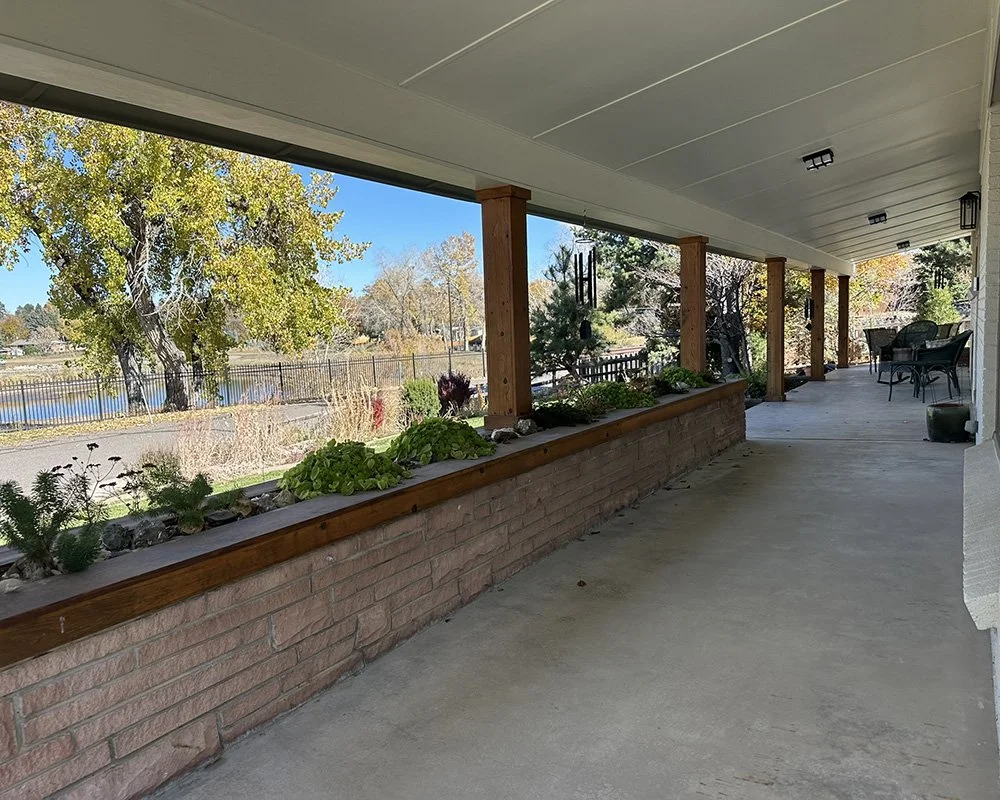 The front porch, wide, north-facing, great views of the reservoir across the street.