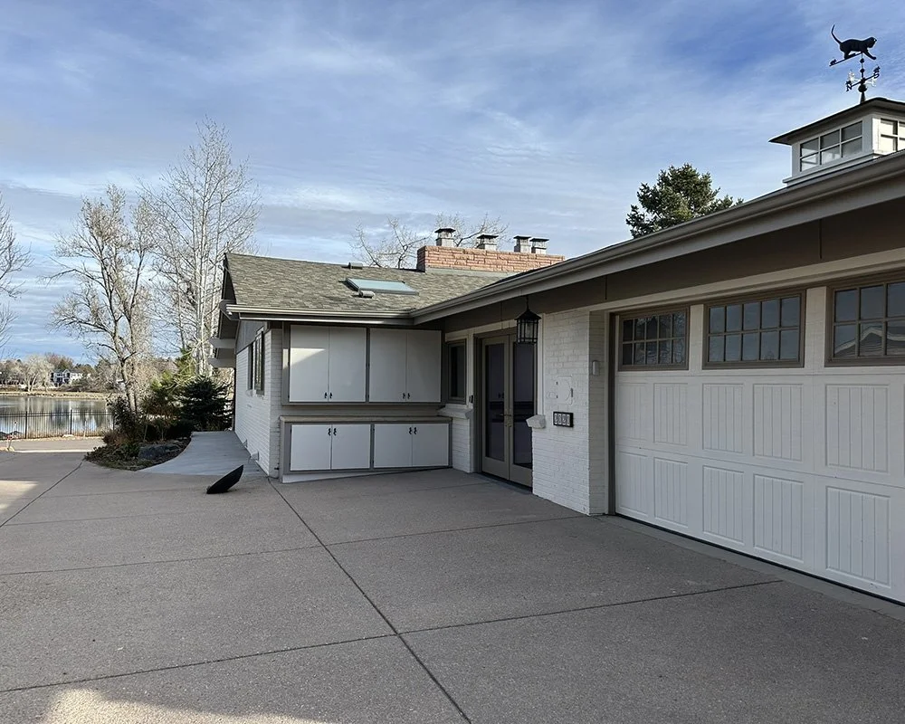 The view from the top of the driveway toward the street. The concrete path along the house leads to the front porch.