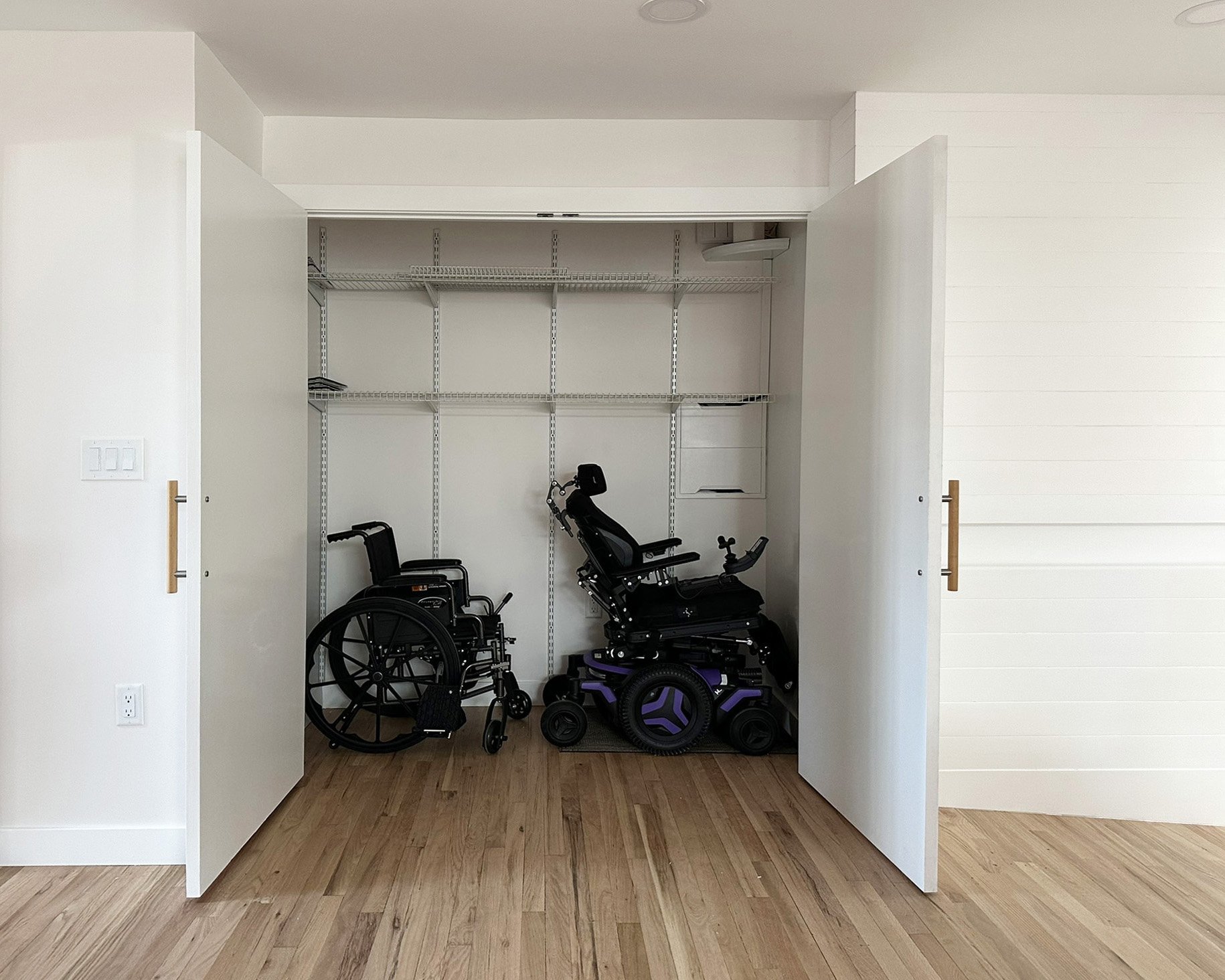 Wheel chair parking in the closet with adjustable shelving.