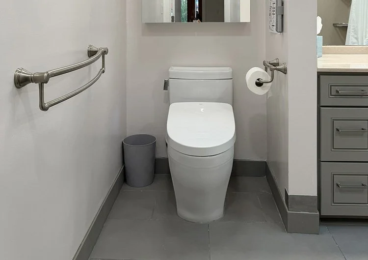 There's a toilet with a bidet seat in the main bathroom. The towel bars double as grab bars.