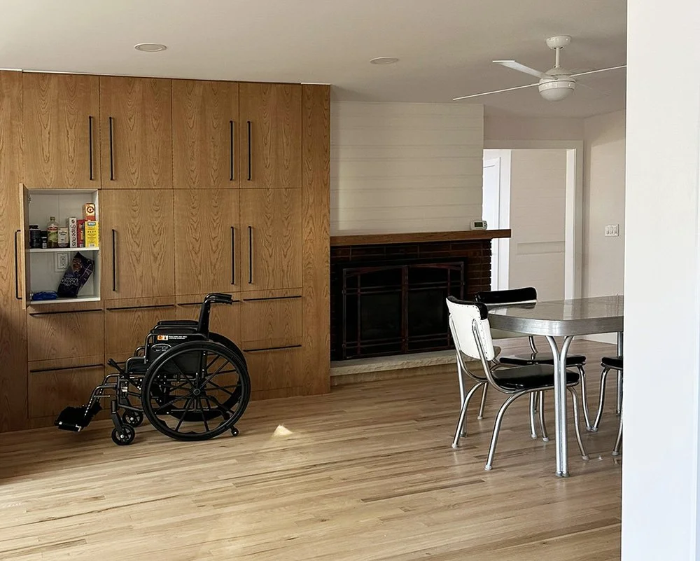 A floor to ceiling pantry cupboard in the dining room; shallow shelving makes reaching easier.