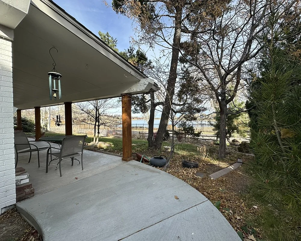 A concrete path lead to the front, north-facing front porch. Views of the reservoir beyond. 
