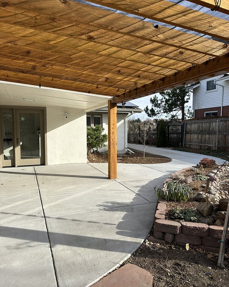 Rear patio door exit from laundry room (no stairs). A roof covers a portion of the patio, a perola covers the other portion. 