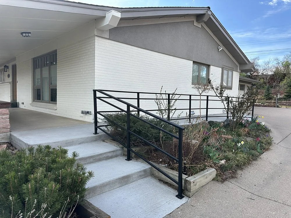 The front porch via stair or ramp from the driveway. 