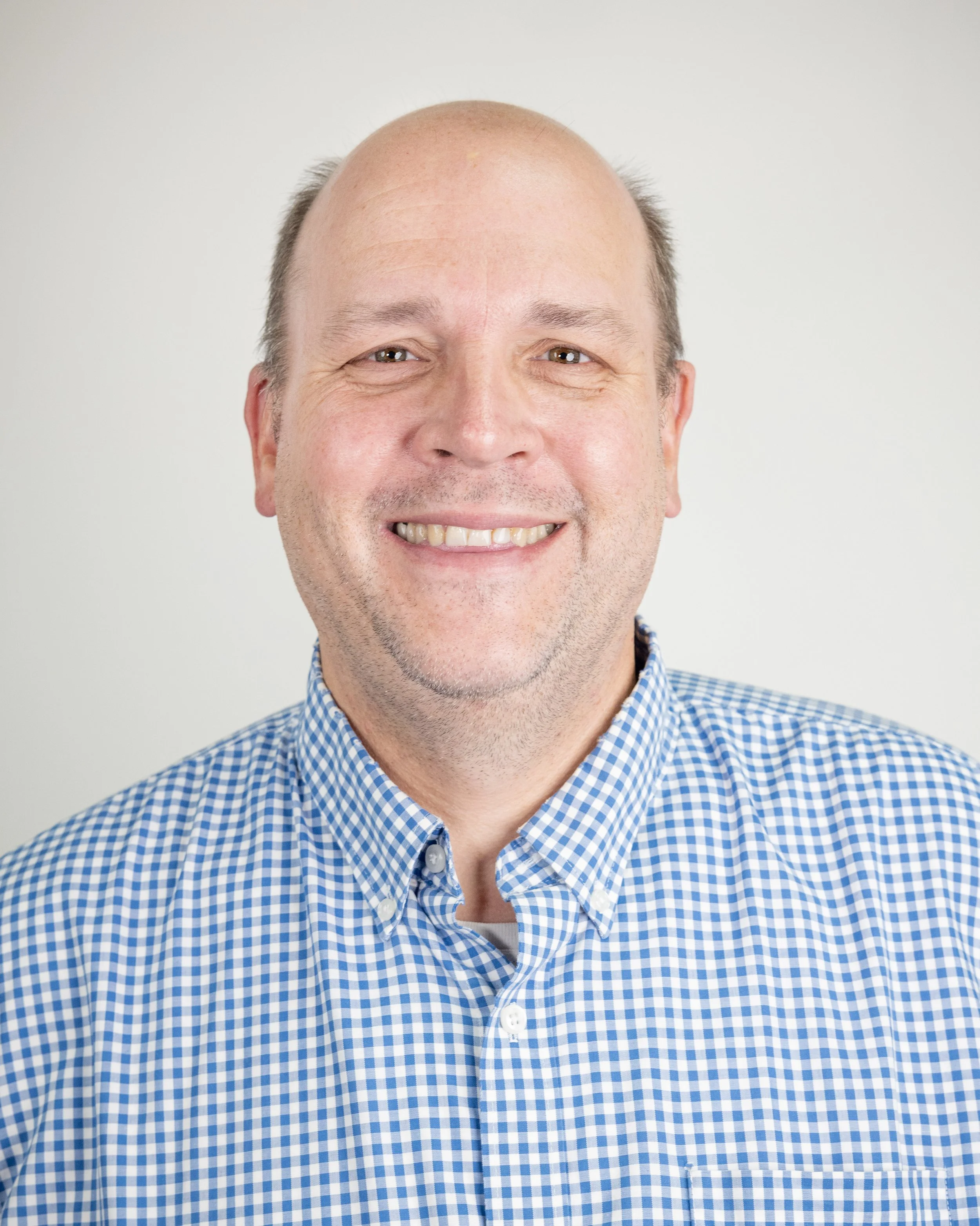 Smiling man in a checkered shirt