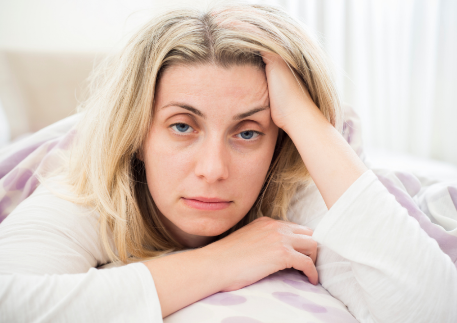 A woman Struggling to fall asleep, stay asleep, or switch off a busy mind at night.