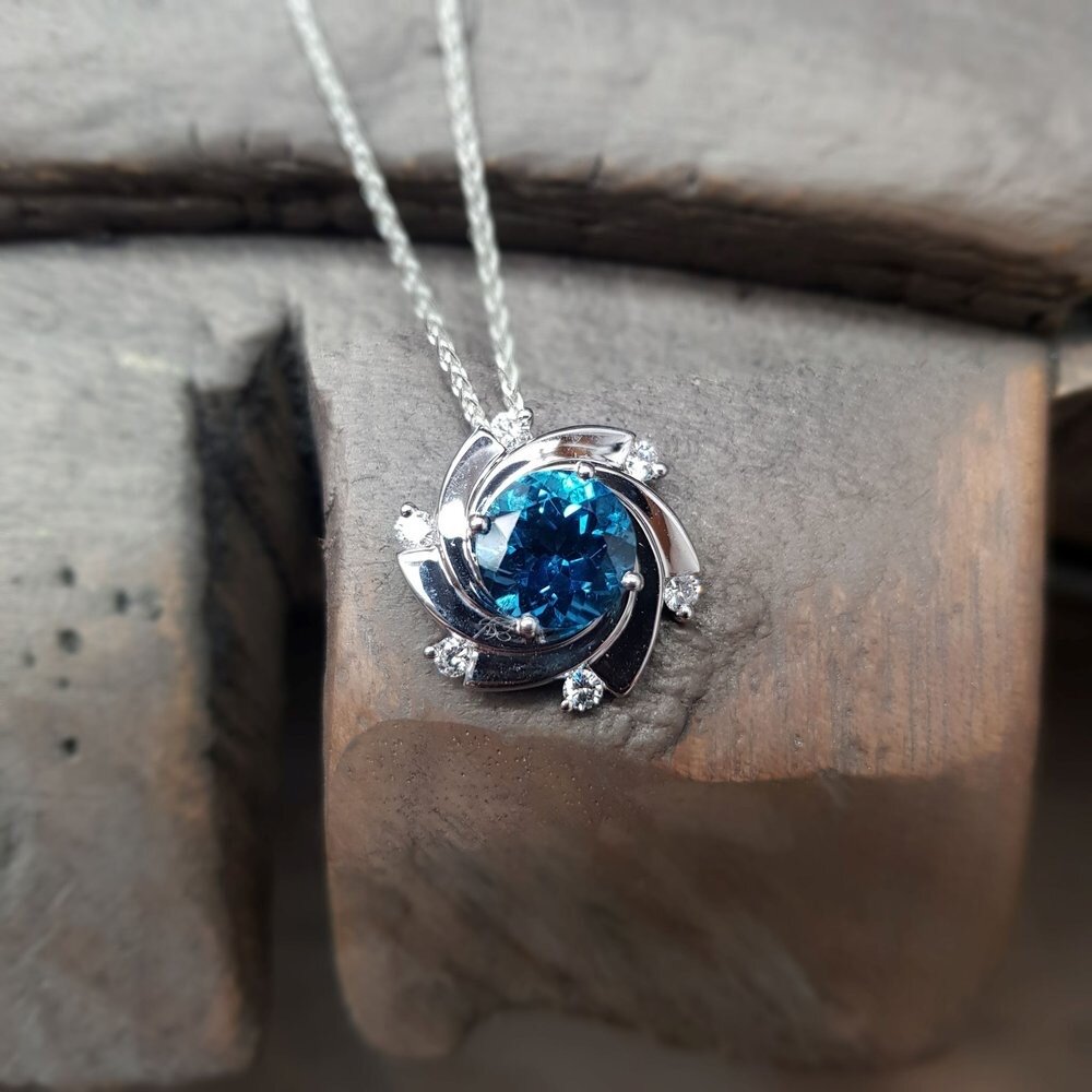 Capture attention with the enchanting beauty of the Aurora Pendant! ✨💙 

Radiating with the brilliance of Swiss Blue Topaz and round brilliant cut diamonds, its dynamic, twisting design captures attention effortlessly!

Available in 9ct white gold o