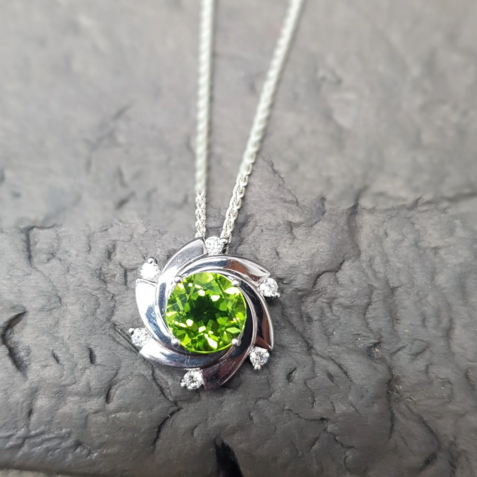 Aurora originally started out as a tiny stud earring before we decided to grow it to a perfect pendant size.  We love it's versatility - the focus being the colour of the central stone.  Currently it's on the shelf with a bright Peridot, but if you f