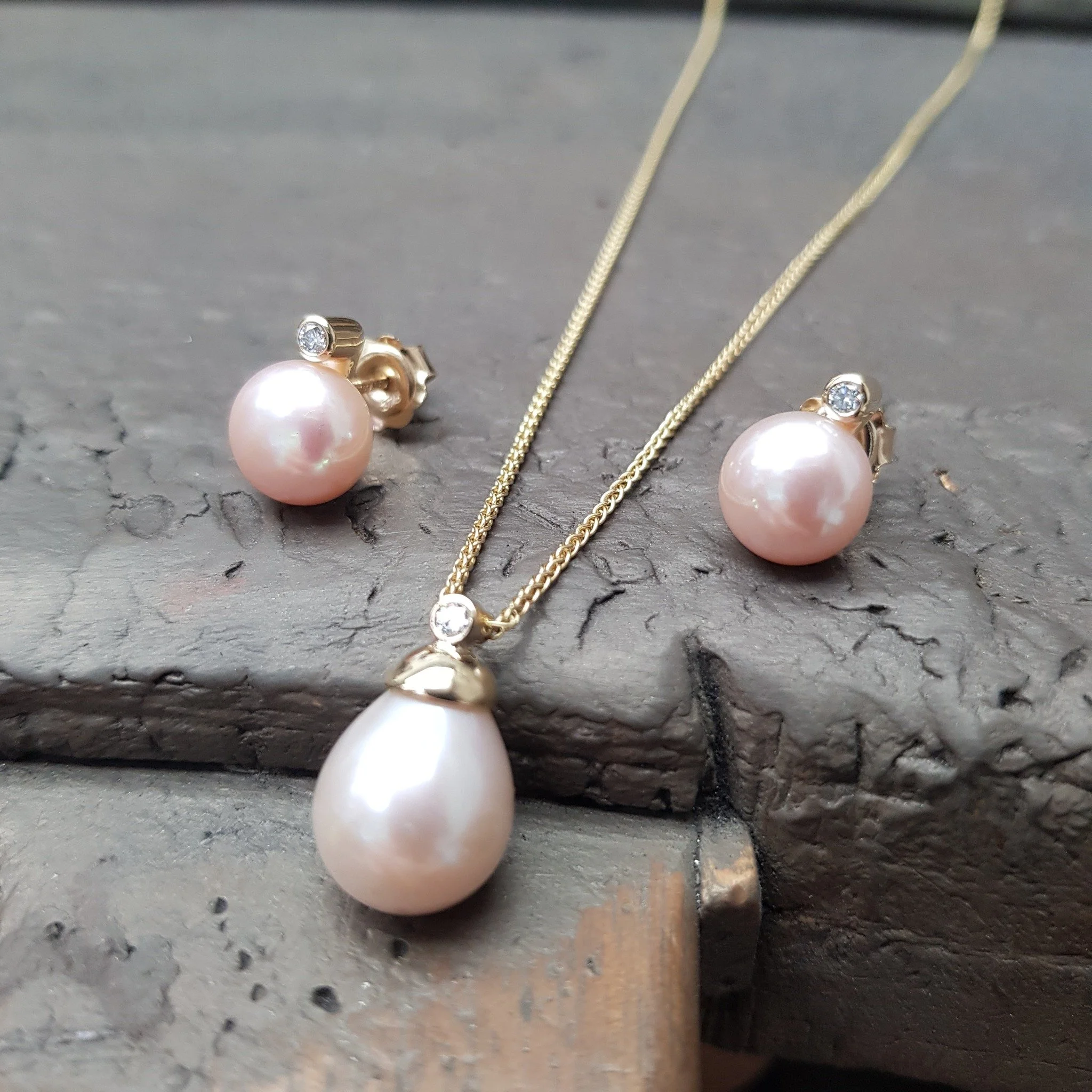 These peachy pink pearls are such a lovely warm colour - we've set them in 9ct Yellow gold with a diamond to bring just a little extra twinkle. 

Tear Drop Pink Pearl &amp; Diamond Pendant &pound;870
Pink Button Pear &amp; Diamond Studs &pound;1,260