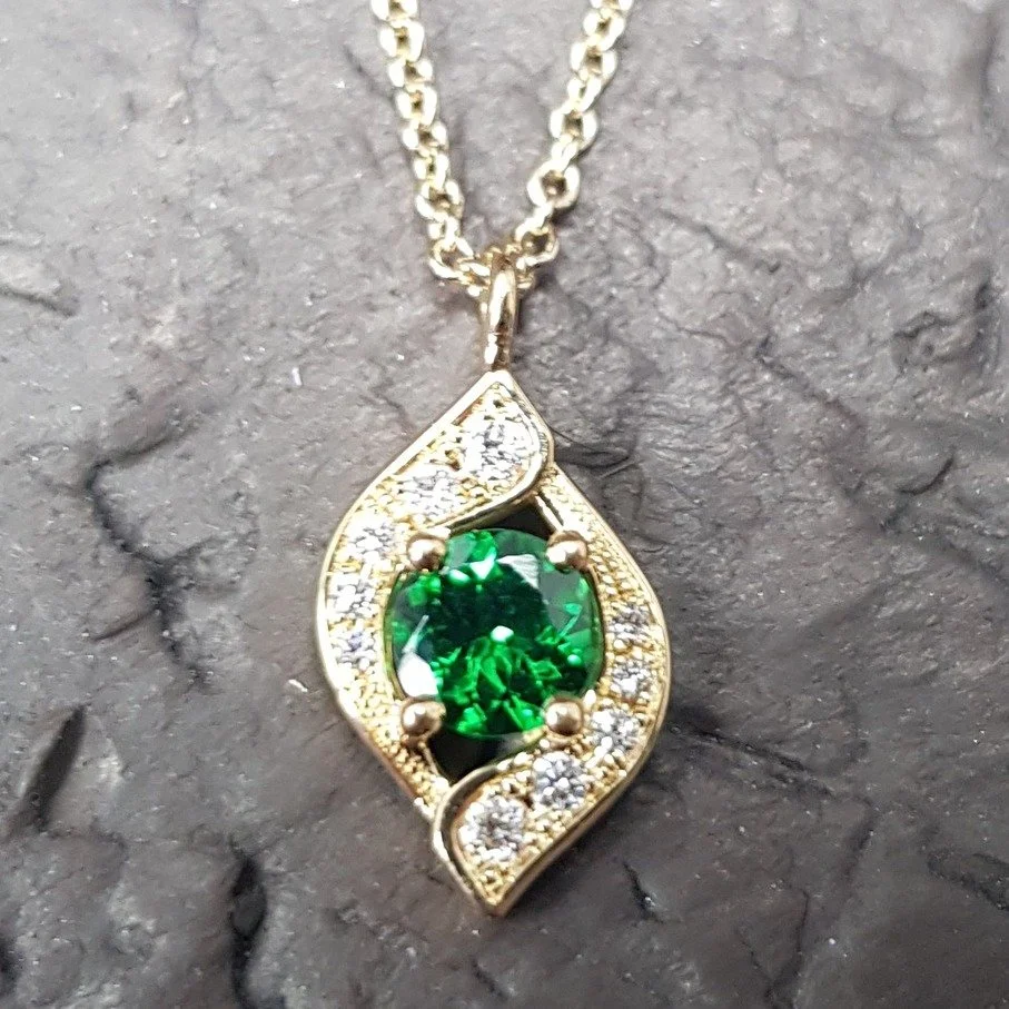The final in the trio of our Embrace pendants.  This one has a central Tsavorite and is set in 9ct yellow gold - beautifully warm colours for this time of year.

Tsavorite and Diamond Embrace pendant &pound;1,444. Call, pop in or DM us for more detai