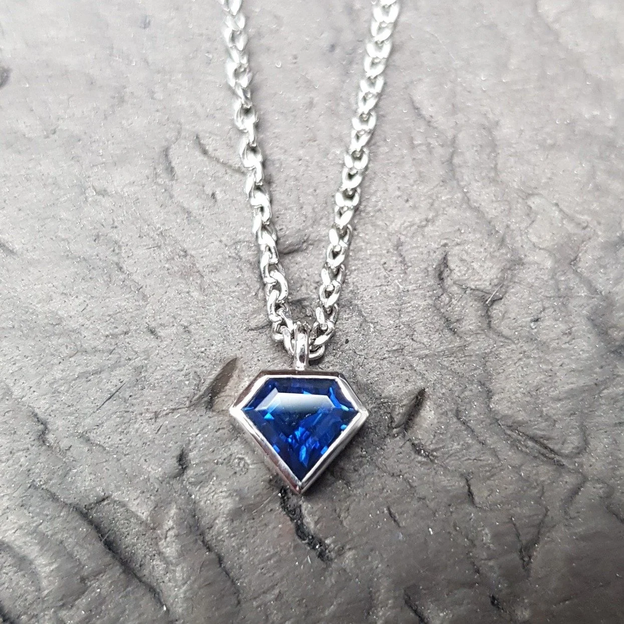 This is a super delicate pendant, wearable as an everyday piece and set with a diamond shaped deep blue Sapphire in Platinum. 

Mini Blue Sapphire Pendant &pound;1,383. Call, pop in or DM for more details.