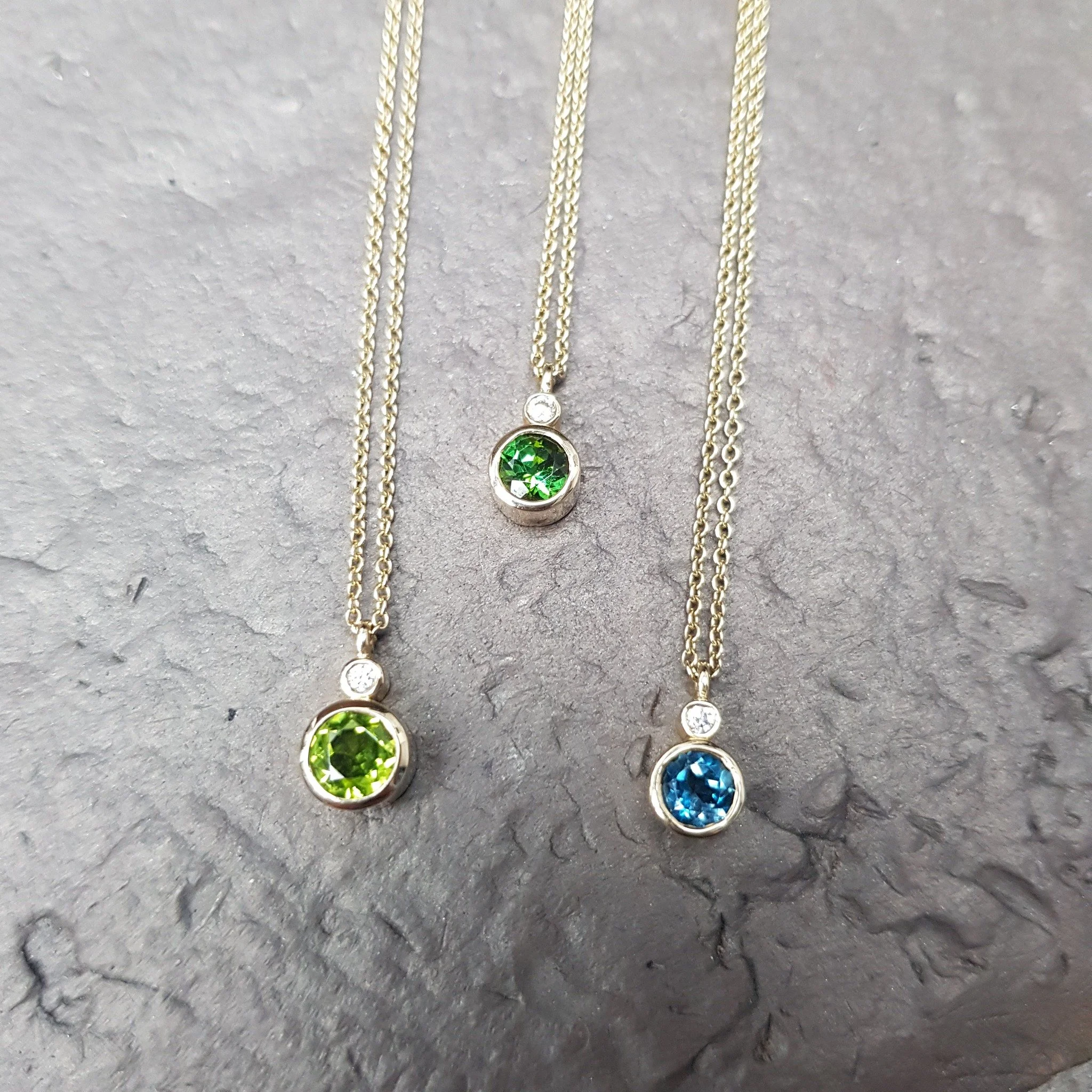 Our Limelight pendant was designed to sit alongside our Limelight stacking rings - simply set in a full bezel with a diamond above - we've made these elegant pendants in a vast variety of stones - these three are currently on the shelves all set in 9