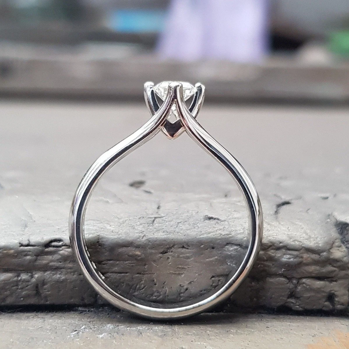 Meaning &lsquo;little crown', our Coronet Engagement Ring is truly that -  a unique Simon Pure design holding a solitaire, brilliant cut diamond which we can adapt to your preference. The delicate compass claw setting floods the diamond with light to