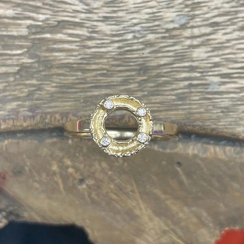 Part of our iconic Mini Molten range, this halo ring in solid 9ct yellow gold, set with four sparkly diamonds, is the perfect every day ring with a bit of a twist.  Also available in sterling silver online or instore.