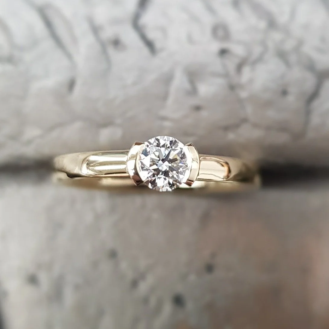 Simple, elegant, timeless - our Pure solitaire ring design can be made in your choice of metal and your size or colour of stone, making it entirely personal to you. This one here is set in 18ct yellow gold with a 0.40cts round brilliant cut diamond. 
