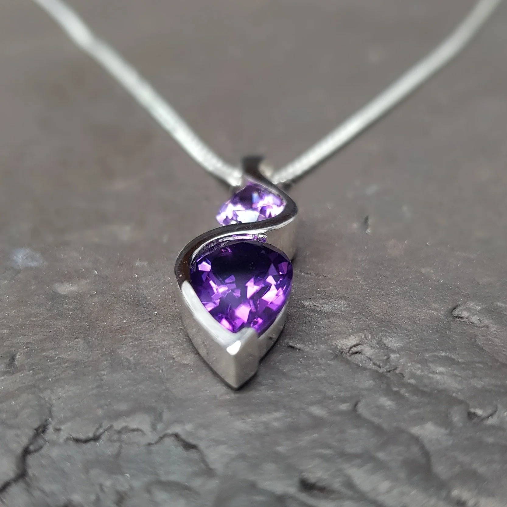 Back on the shelves today and soaking in the sun - our Spirit pendant set with two pear cut Amethysts.