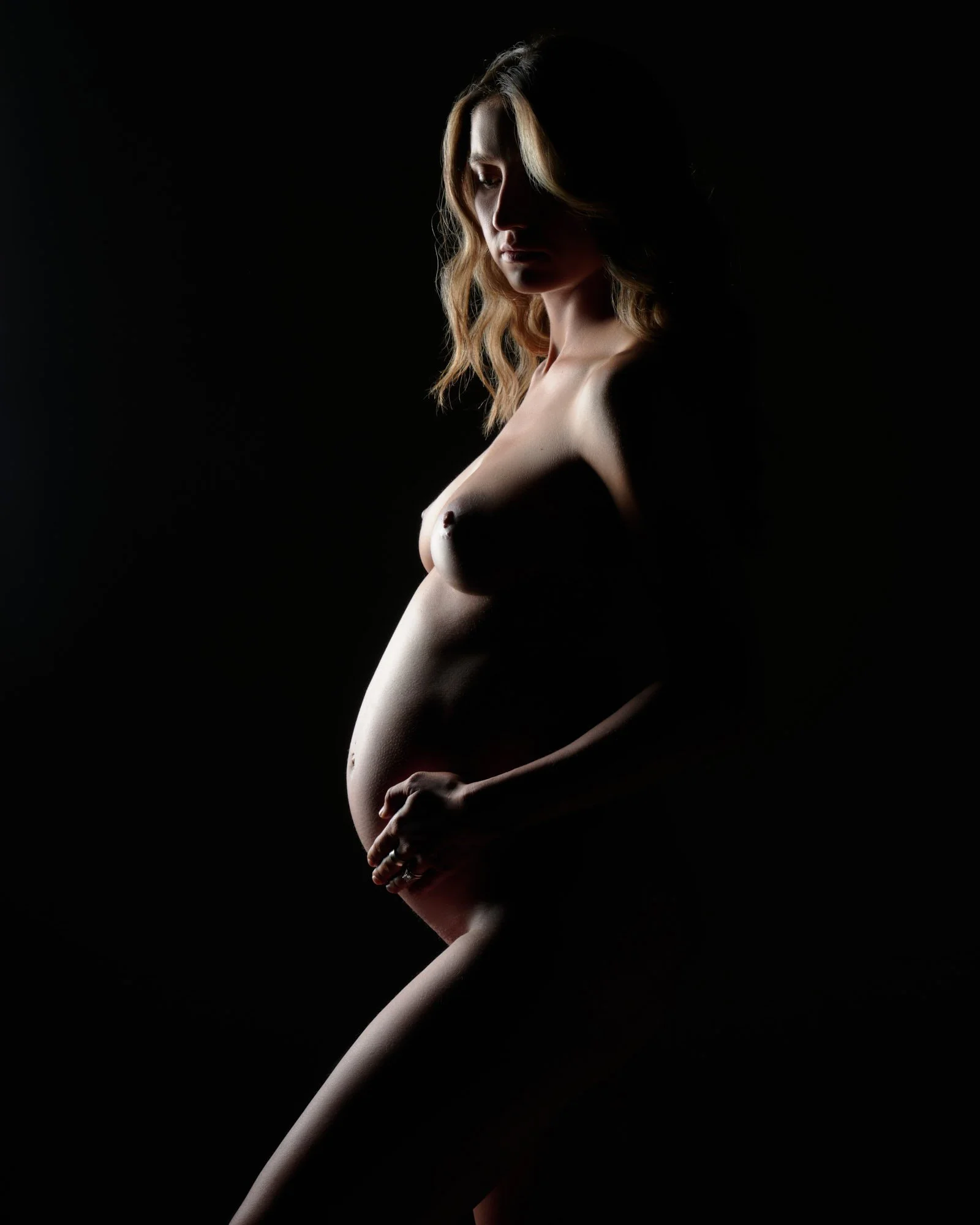 Edge light wrapping the curve of the bump against pure black.