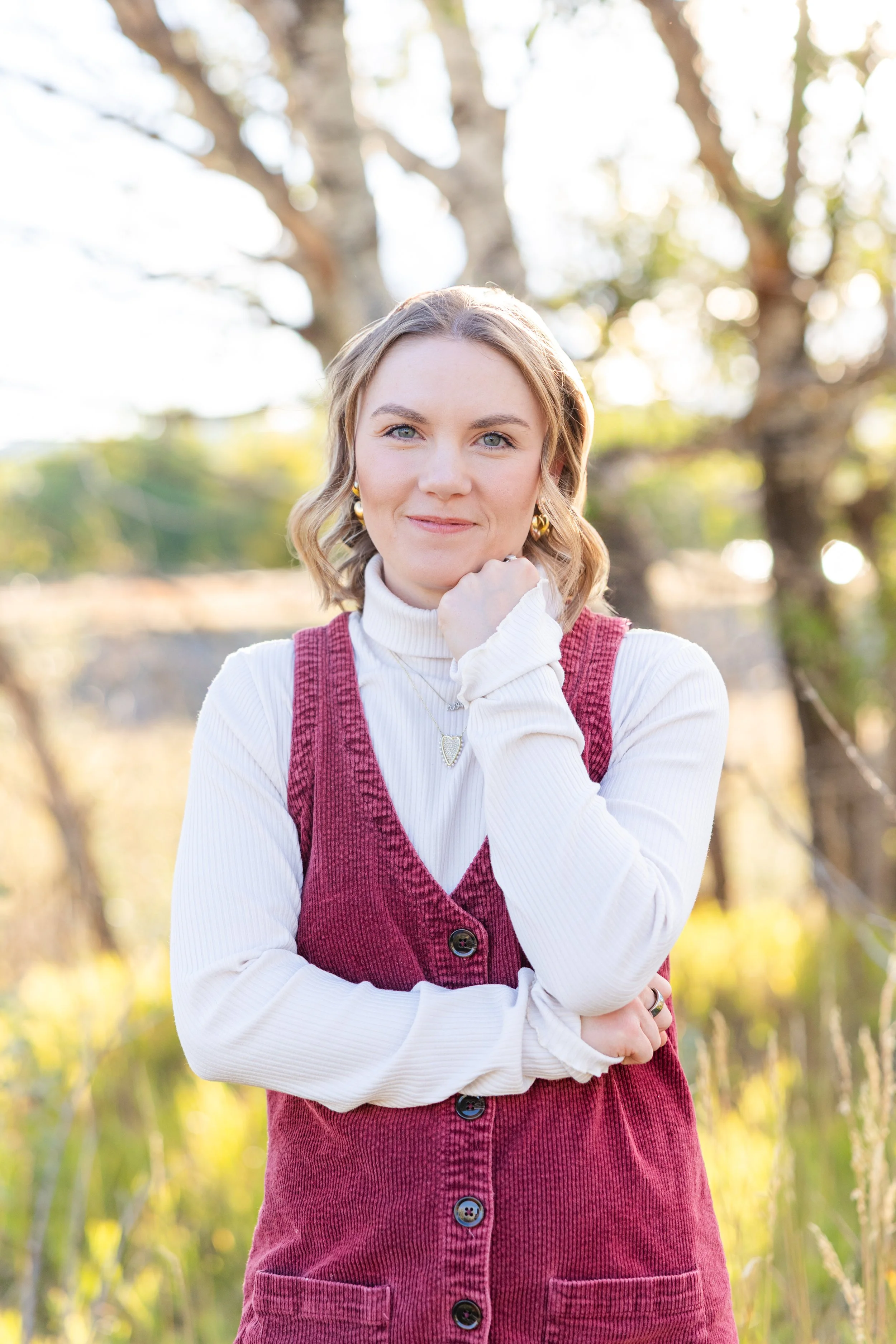 Community Impact Award winner portrait in a red corduroy vest, standing in a winter field.