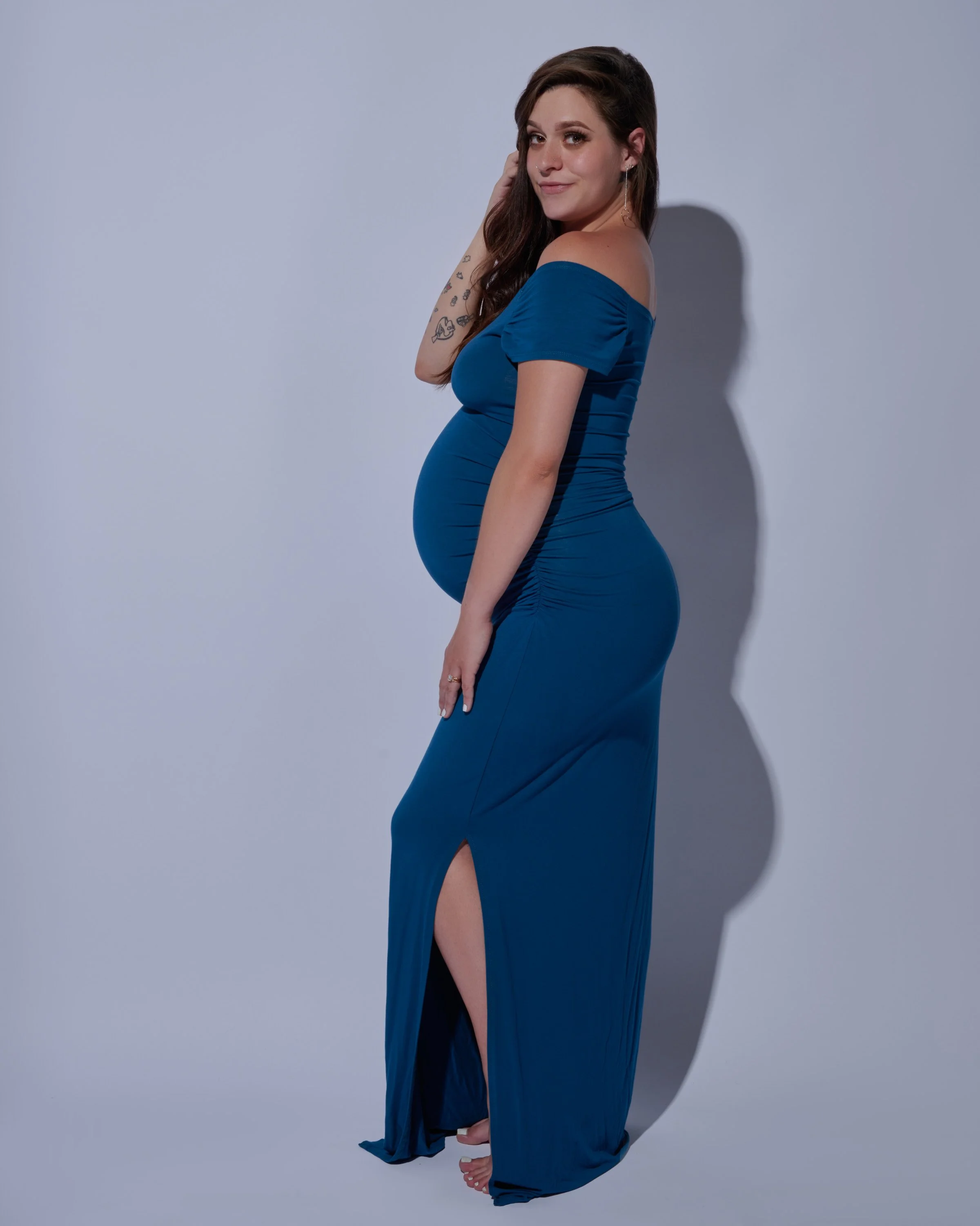 Rich color payoff in a styled gown at a Denver maternity session.