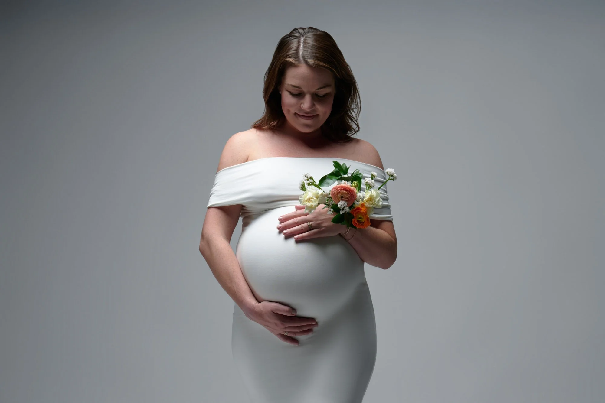Expecting mother in the Denver, Colorado studio, photographed in the ideal window for when to schedule maternity photos.