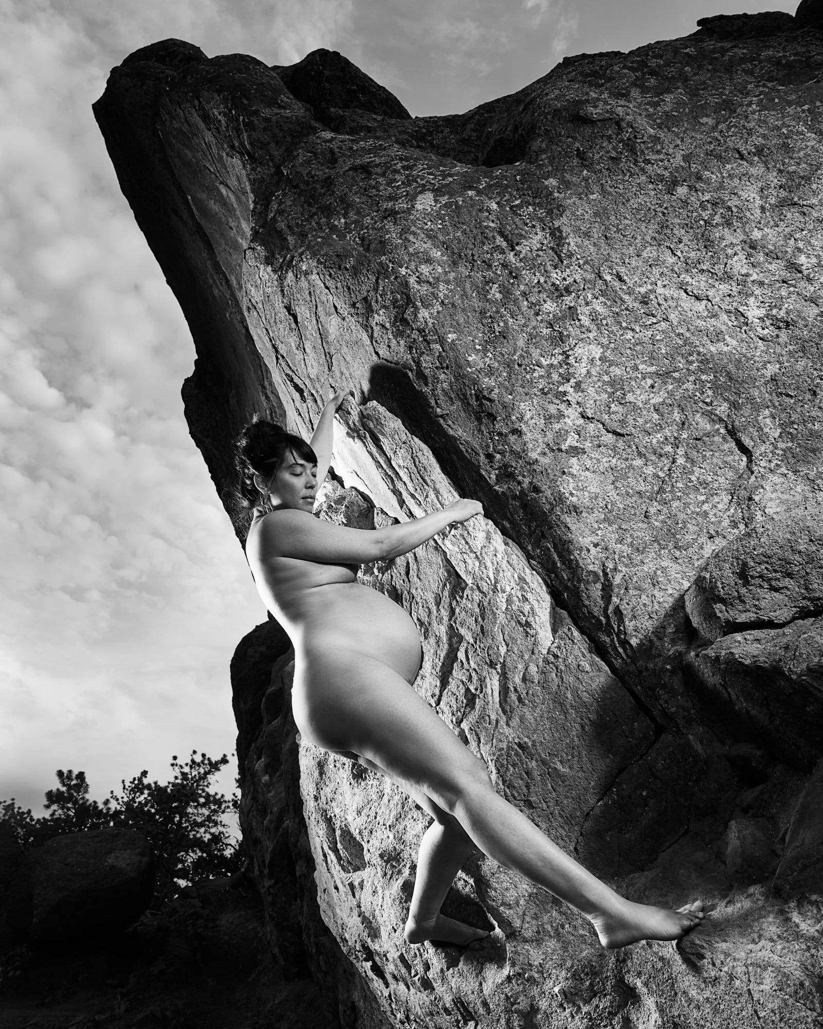 Traversing beneath an overhang in black and white, strength and pregnancy in one line.
