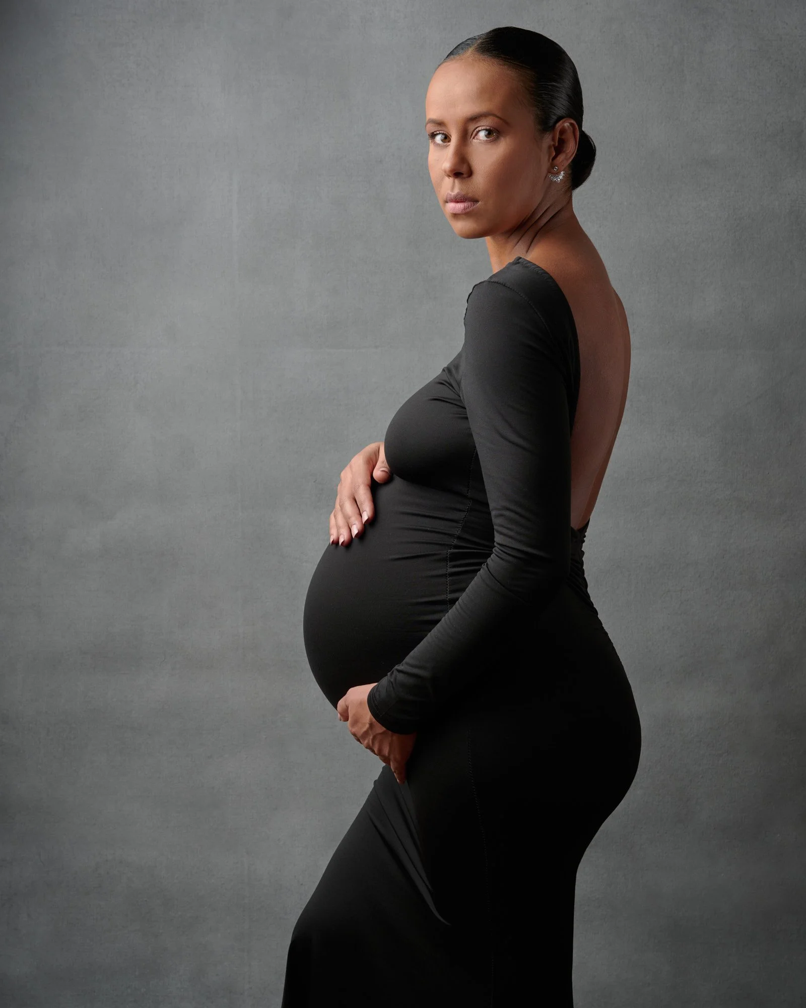 Maternity photo wardrobe colors laid out for a Colorado studio session with Ethan Herrold.