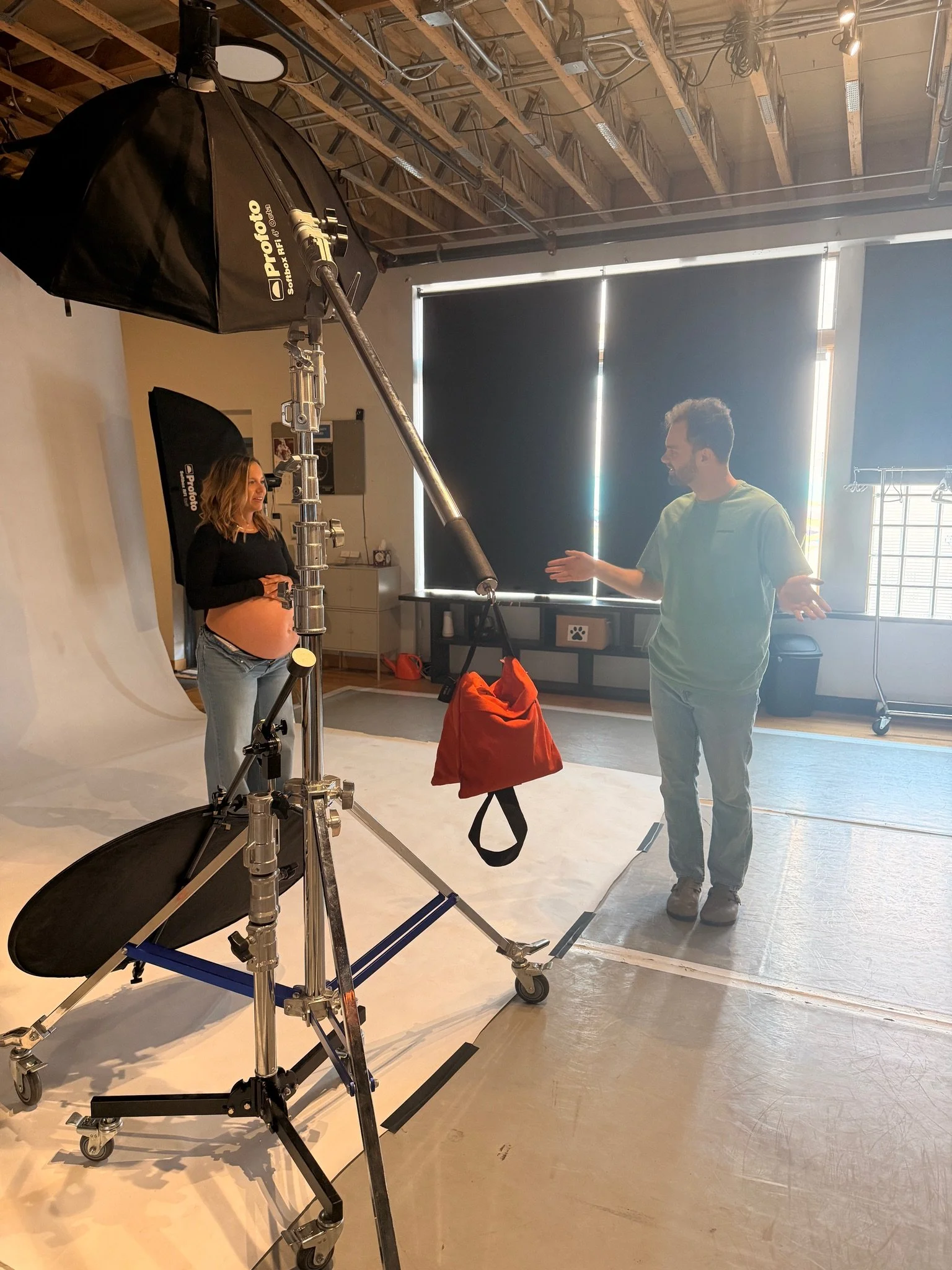 Walking a client through the set between lighting stands.