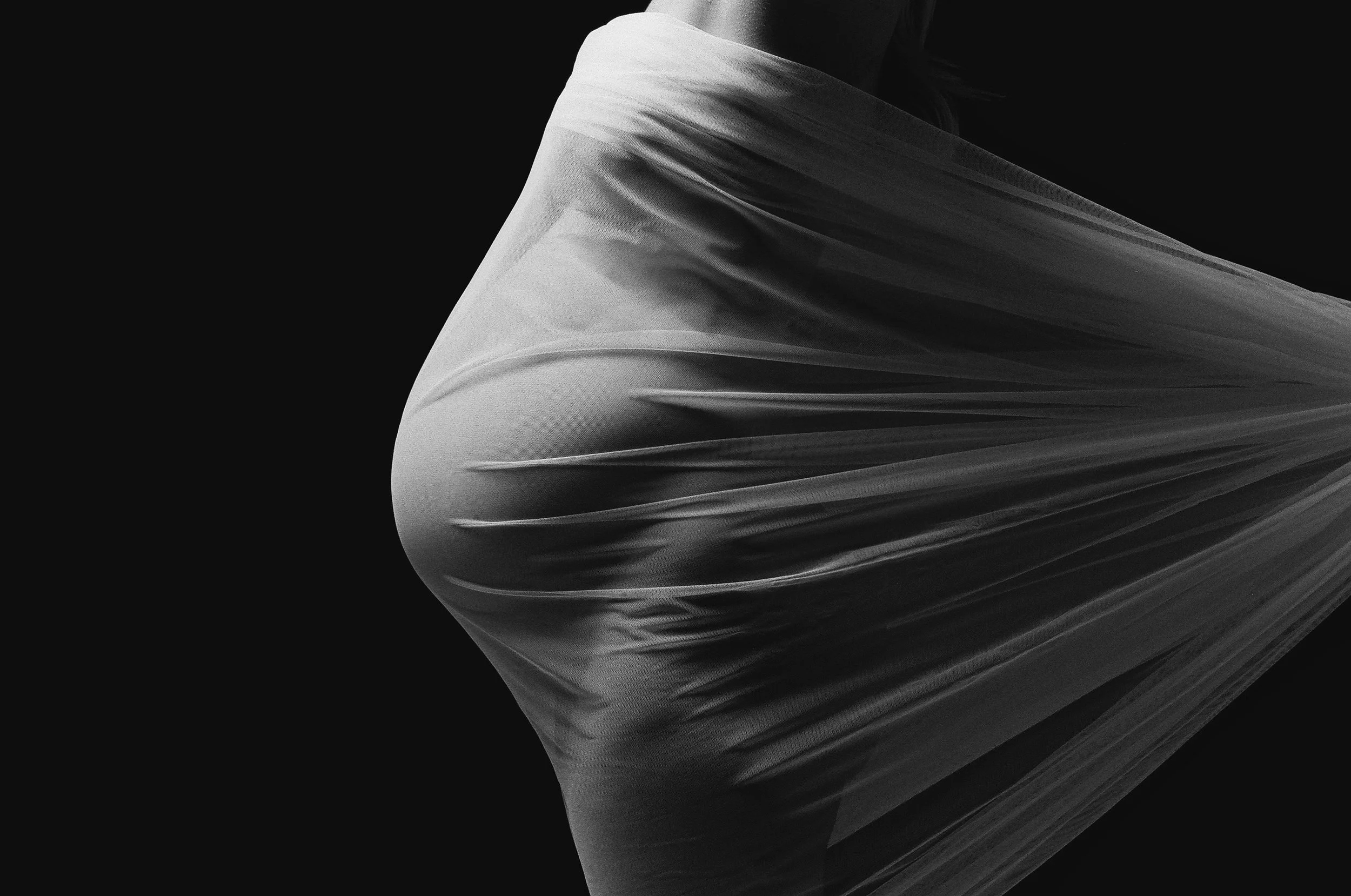 Sheer fabric stretched tight across the bump, black and white on medium format film.