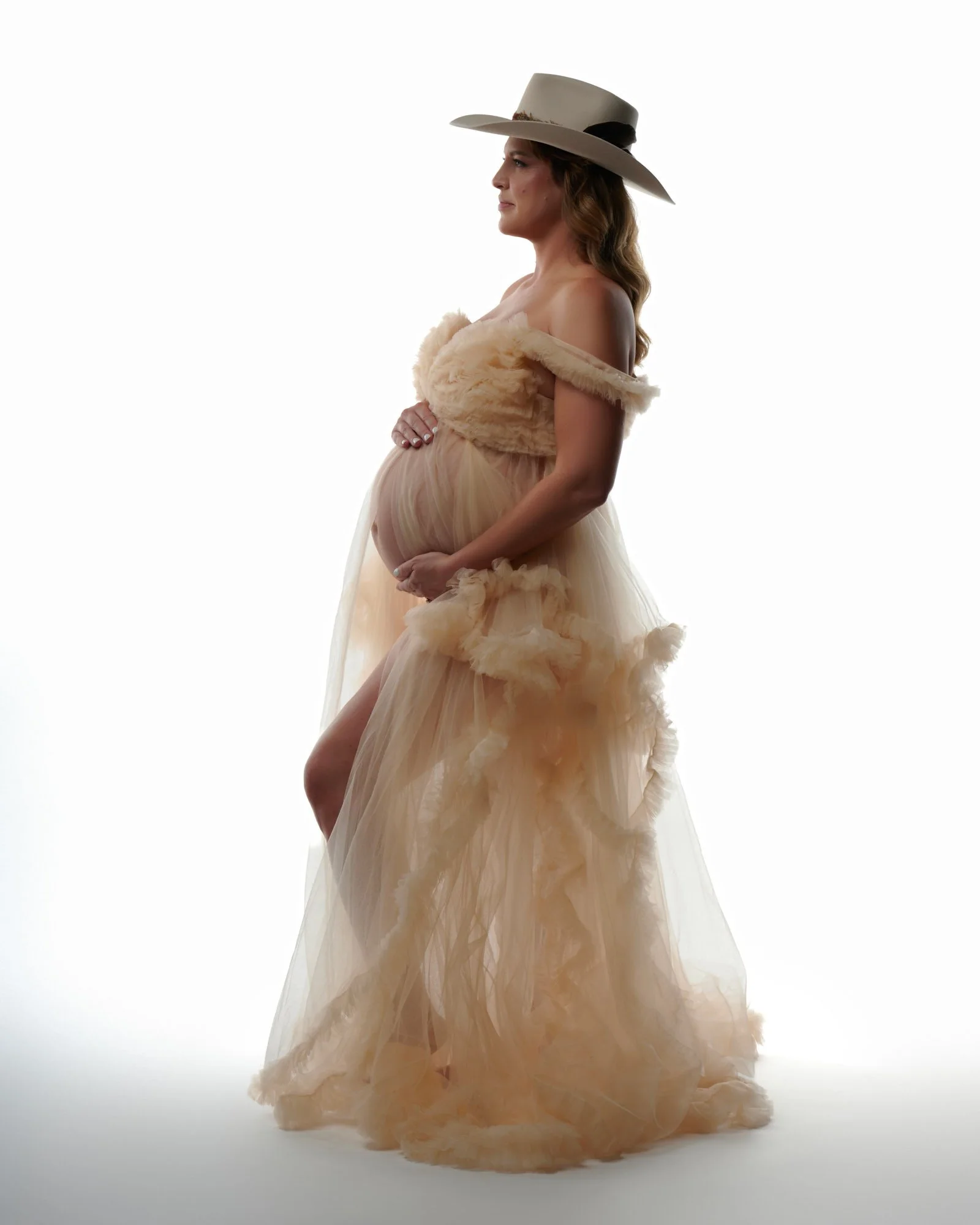 Dramatic red gown with flowing fabric during Colorado maternity shoot