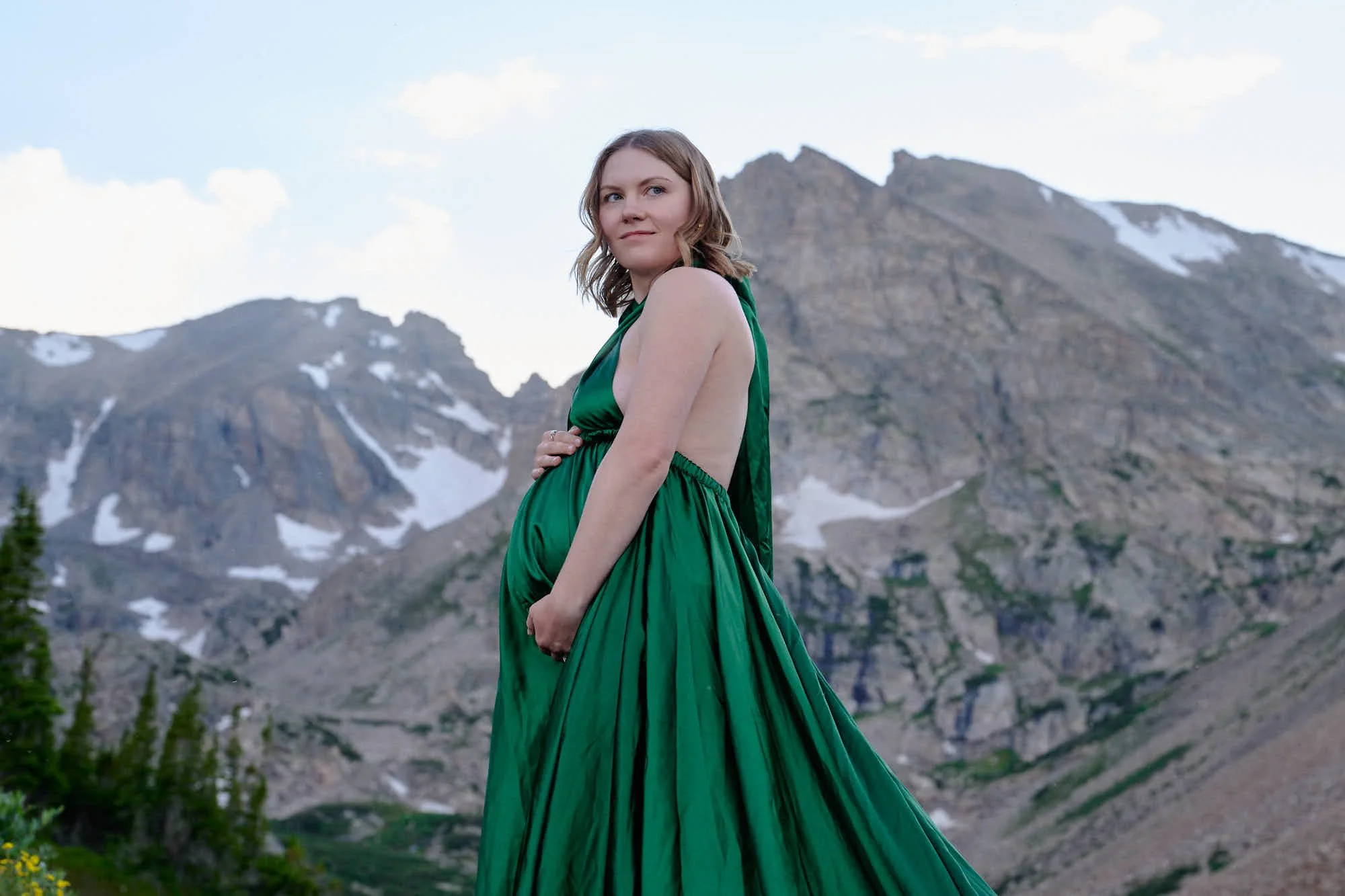 Emerald gown spread across granite with the Indian Peaks behind during a WanderBump session.