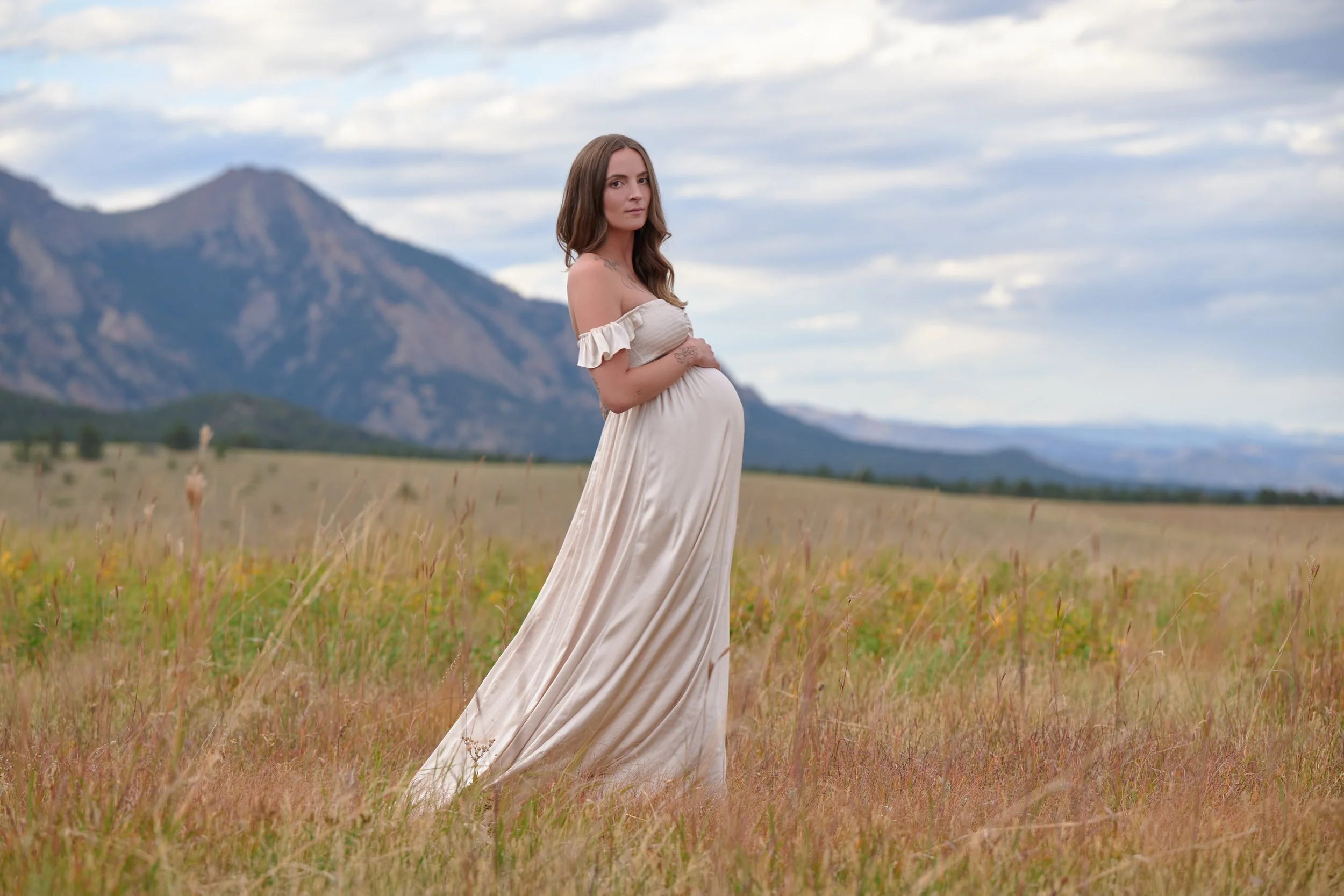 Outdoor maternity portrait in soft flowy dress near Boulder, Colorado