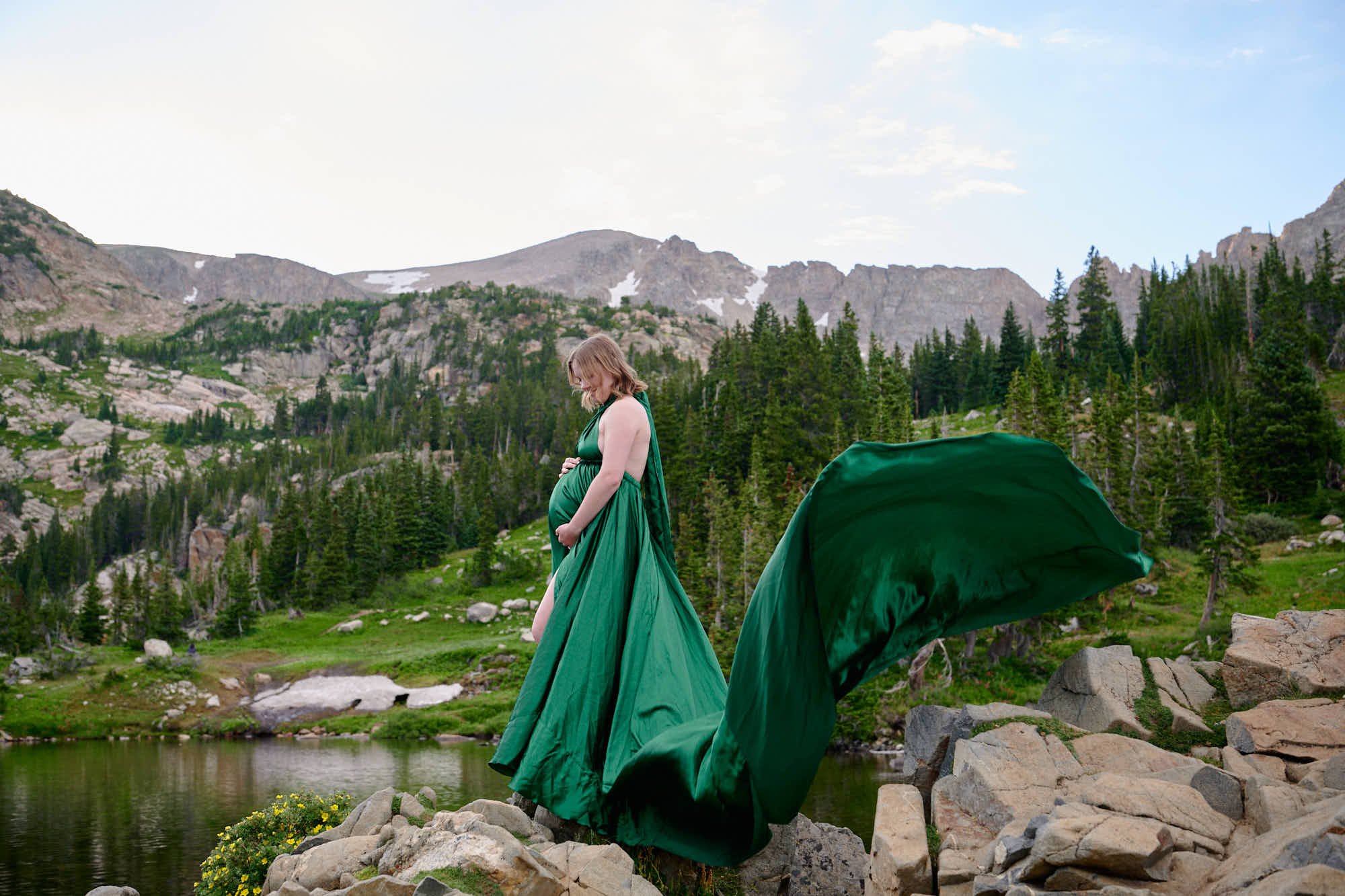 Emerald green parachute gown with a nine-foot train billowing beside an alpine lake.
