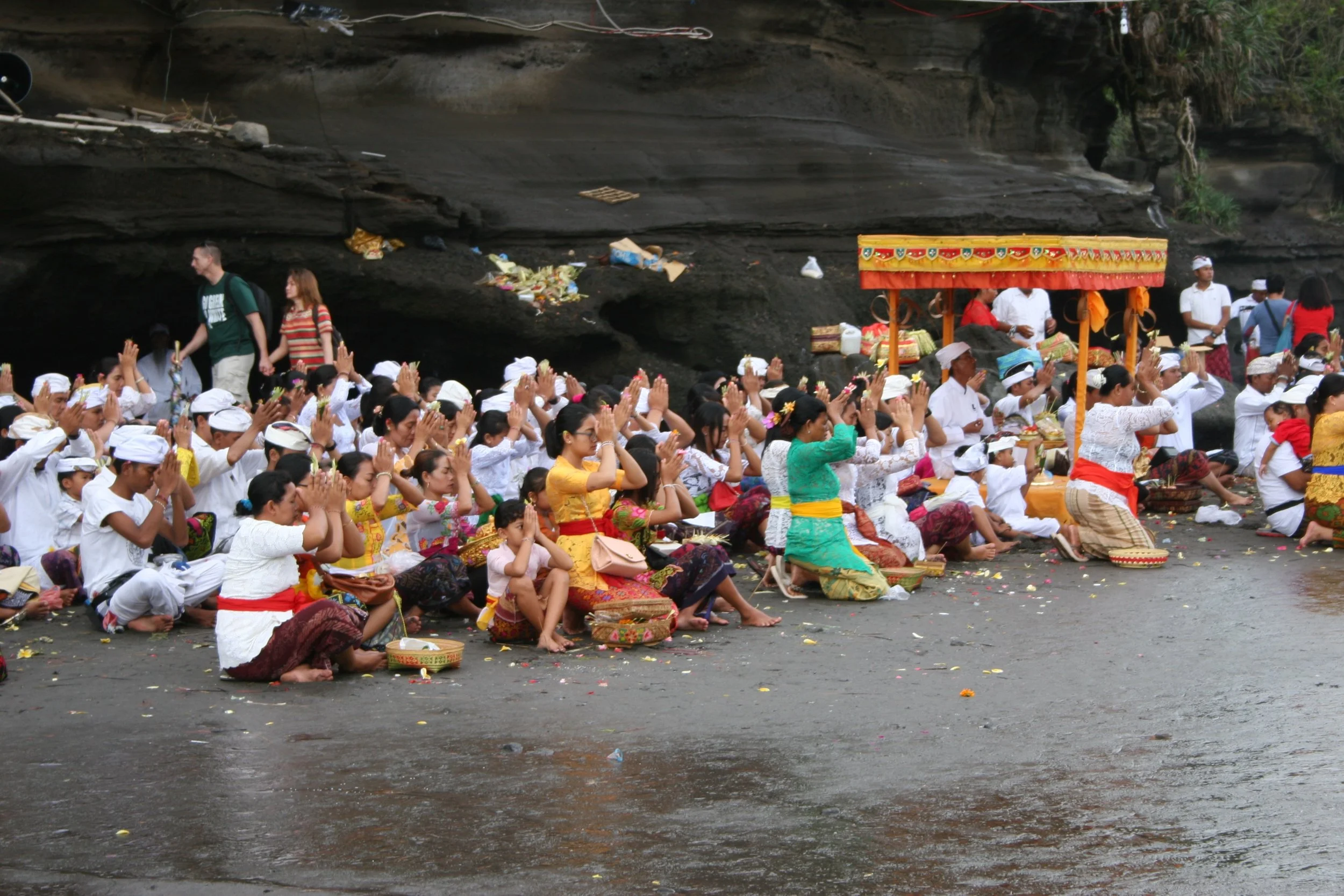 Villagers in white seated for a temple ceremony in Bali