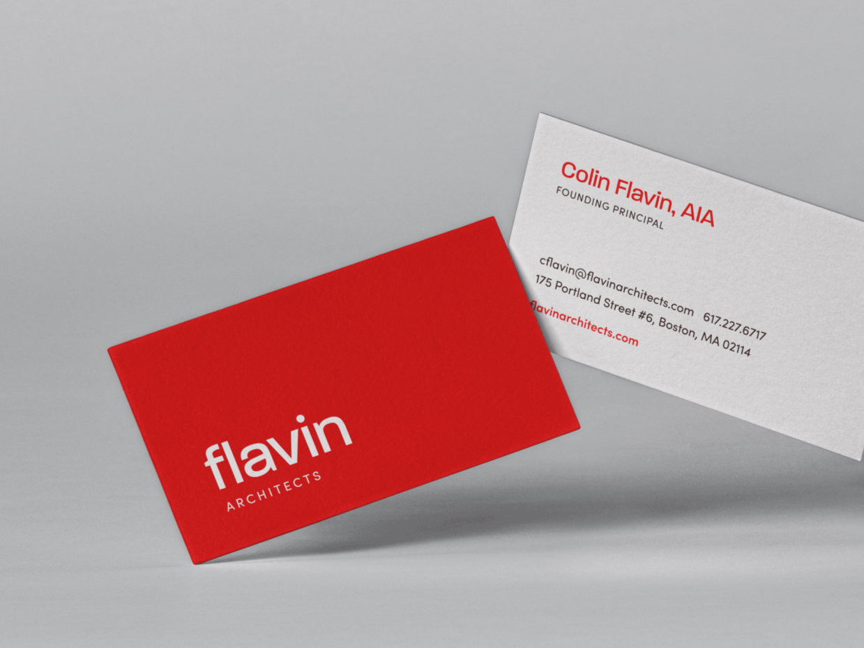 Red business card with white text reading 'flavin ARCHITECTS' and white business card with red and black text, displaying contact information for Colin Flavin, AIA.