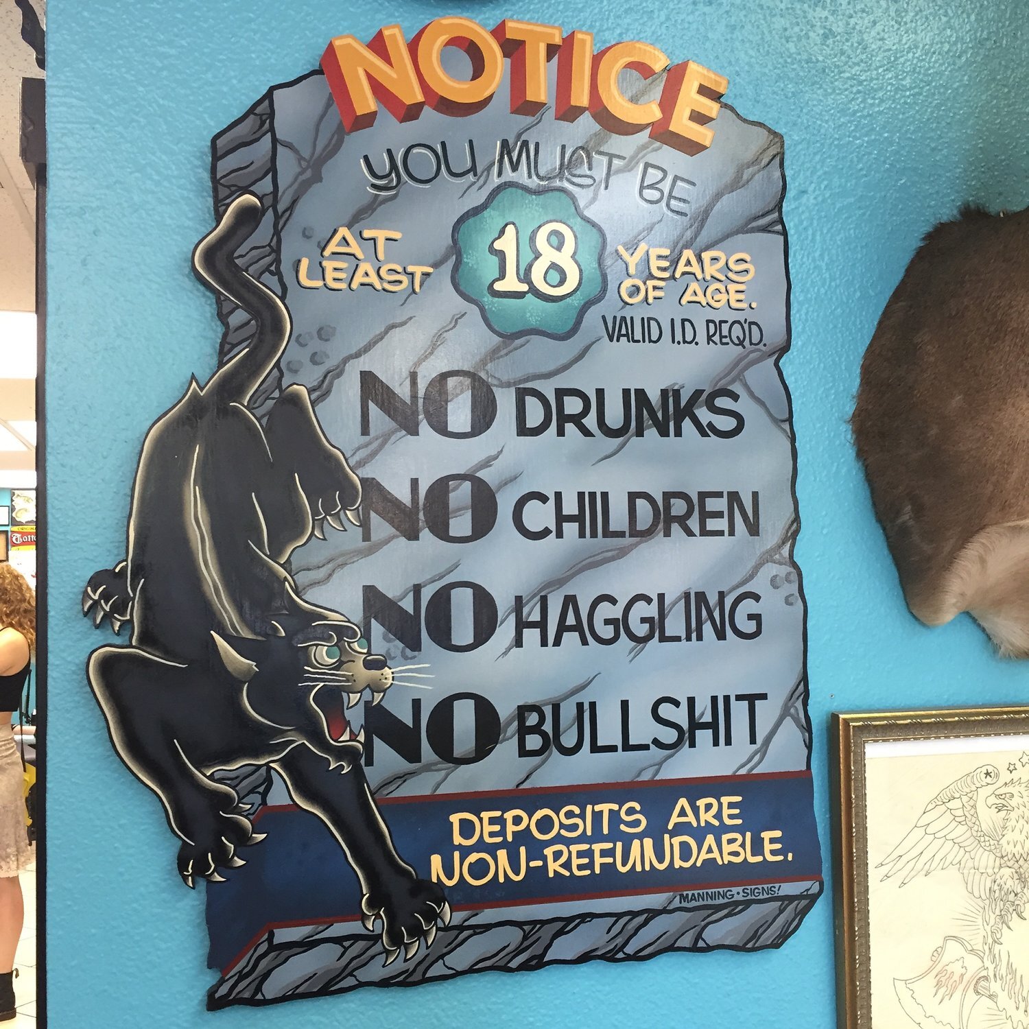 handpainted business rules and notice sign 
