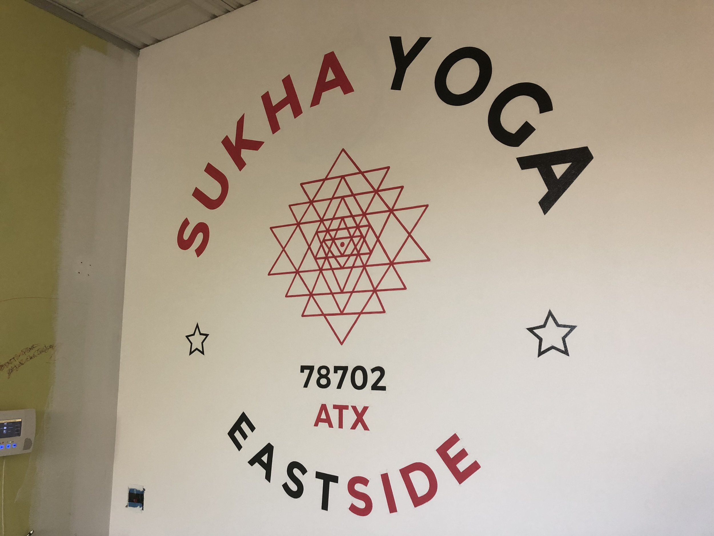 inside mural for sukha yoga by artist andrew manning