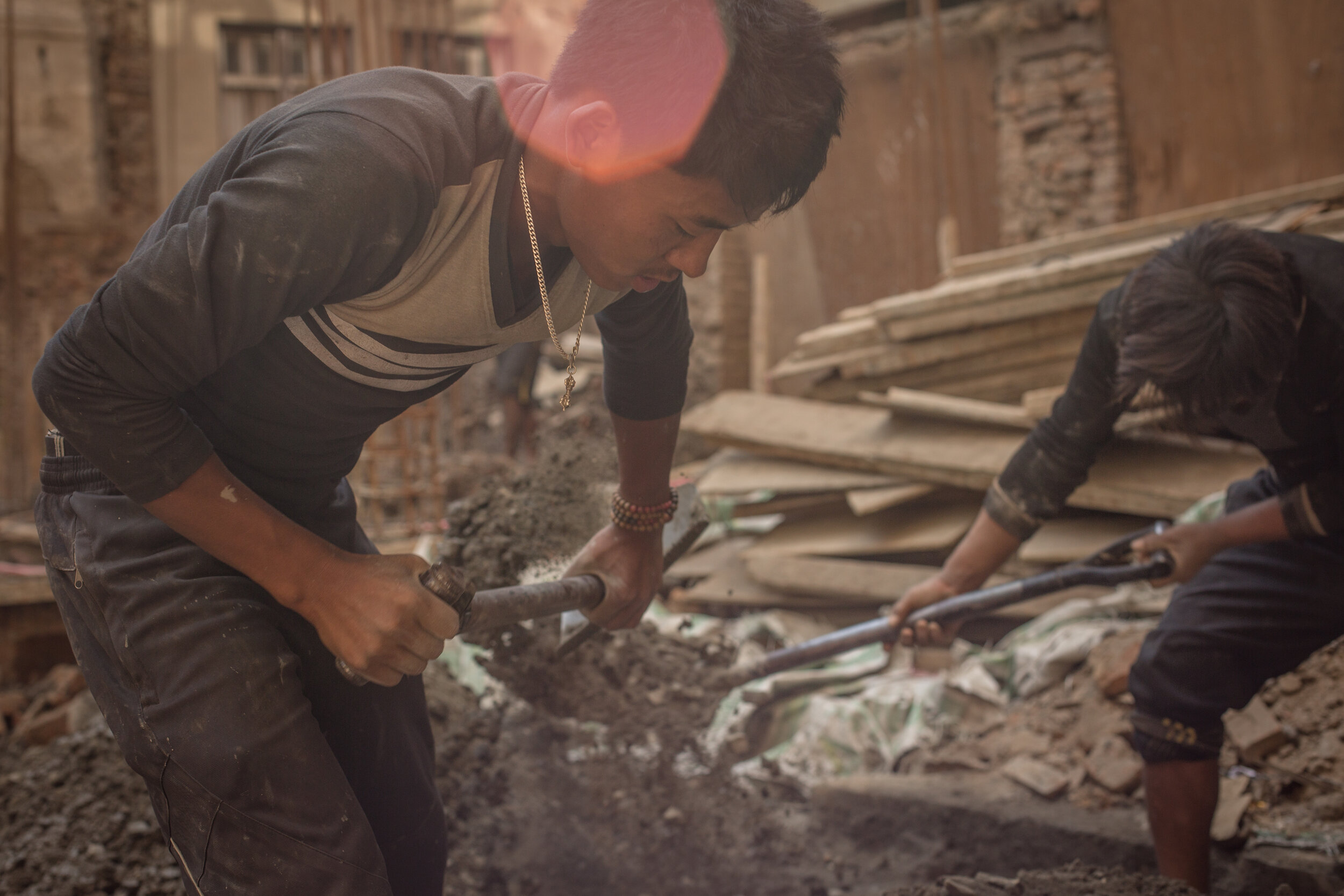 the becoming - a Nepalese boy work hard on the construction site in Nepal. Boys come to Kathmandu to find out what it means to become men (masculinity, manhood, patriarchy)