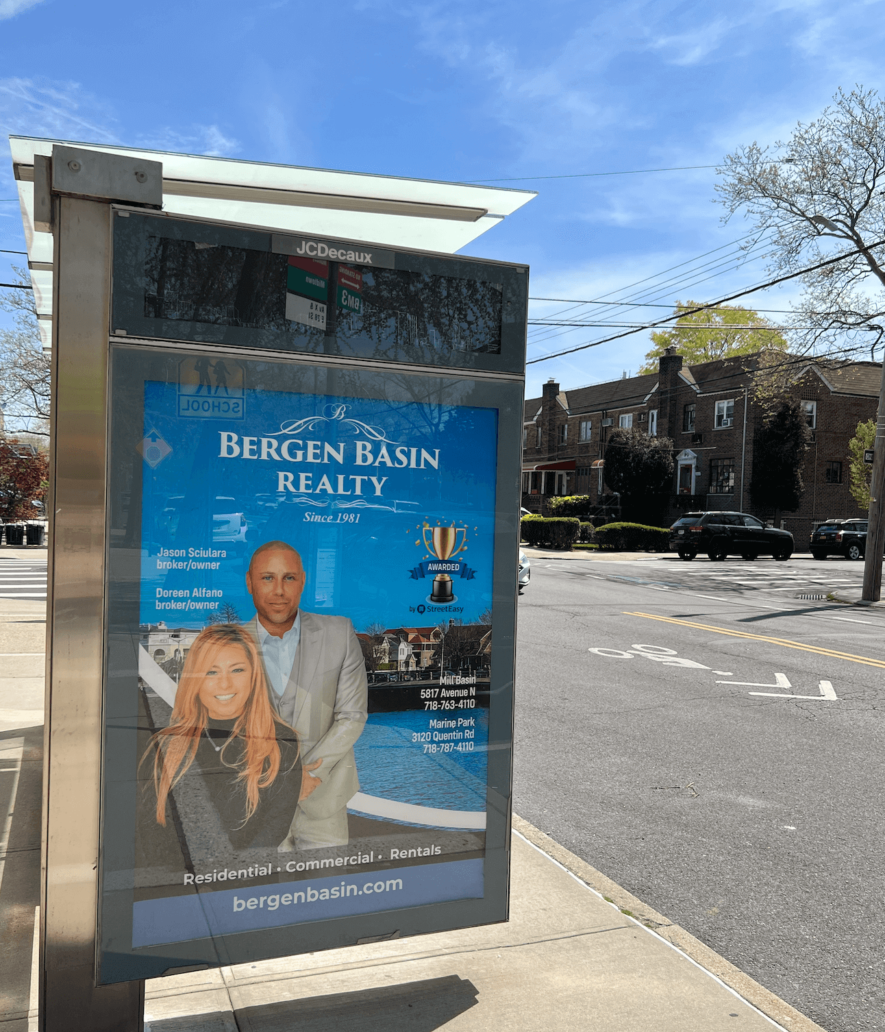 Advertisement for Bergen Basin Realty featuring a man and woman, contact information, and a blue background with water and cityscape images.