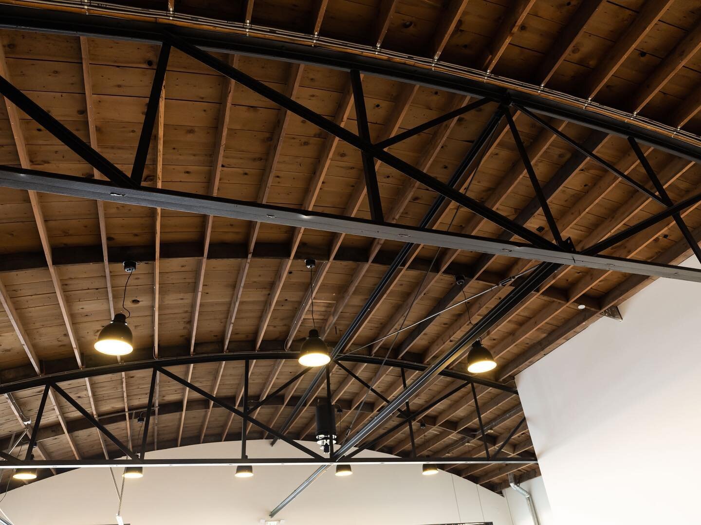 The first feature that caught our eye when we peered into the window of the vacant and gutted shell of a building was this beautiful, wooden barrel roof with the steel bowstring trusses.
