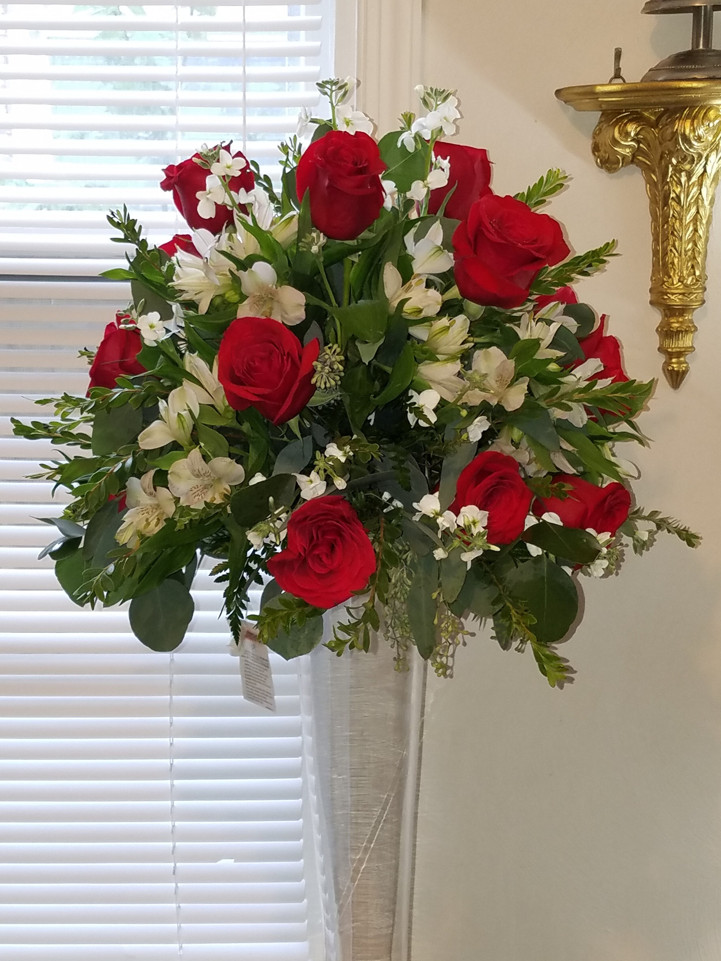 Talk centerpiece Red freedom roses, white spray stock, alstromeria and eucalyptus  Women’s Tea.JPG