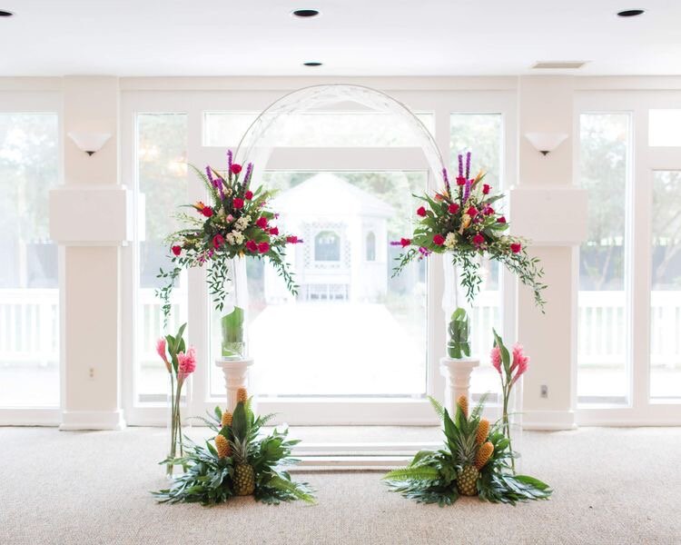 Ceremony arch tropical blooms birds of paradise, pink  ginger and shampoo ginger with Monstera leaves.jpeg