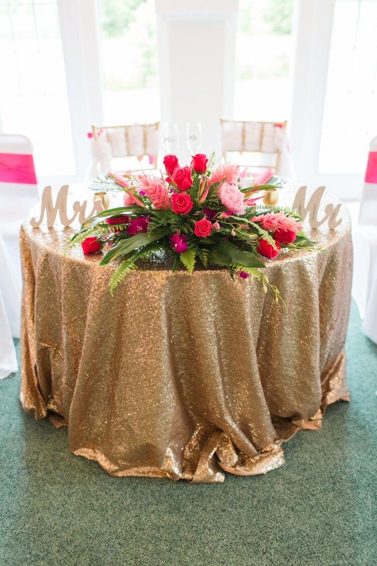 sweetheart table centerpiece with gold sequin table cloth pink peonies, ginger, dendrobium orchids, cherry Oh roses aspidistra and feather fern.jpeg