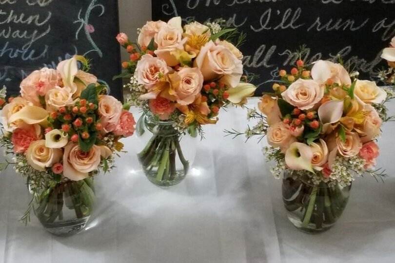 Bridemaids%E2%80%99+hand+tied+bouquets+Shimmer+roses%2C+Mango+Calla+Lillies%2C+Hypericum%2C+peach+pixie+carnations+and+wax+flower.jpg