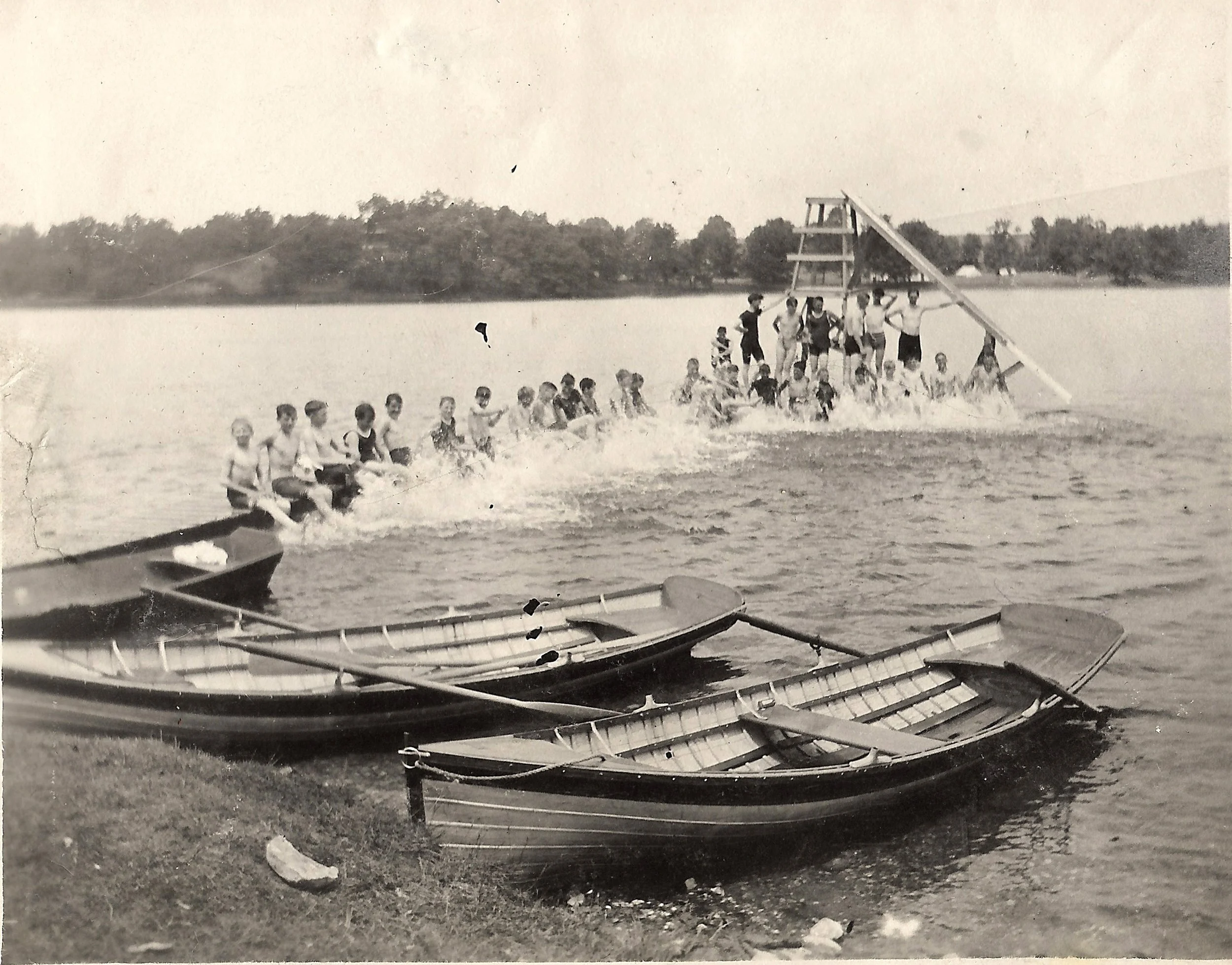 1900s - Campers sit on their pier practicing their kicking