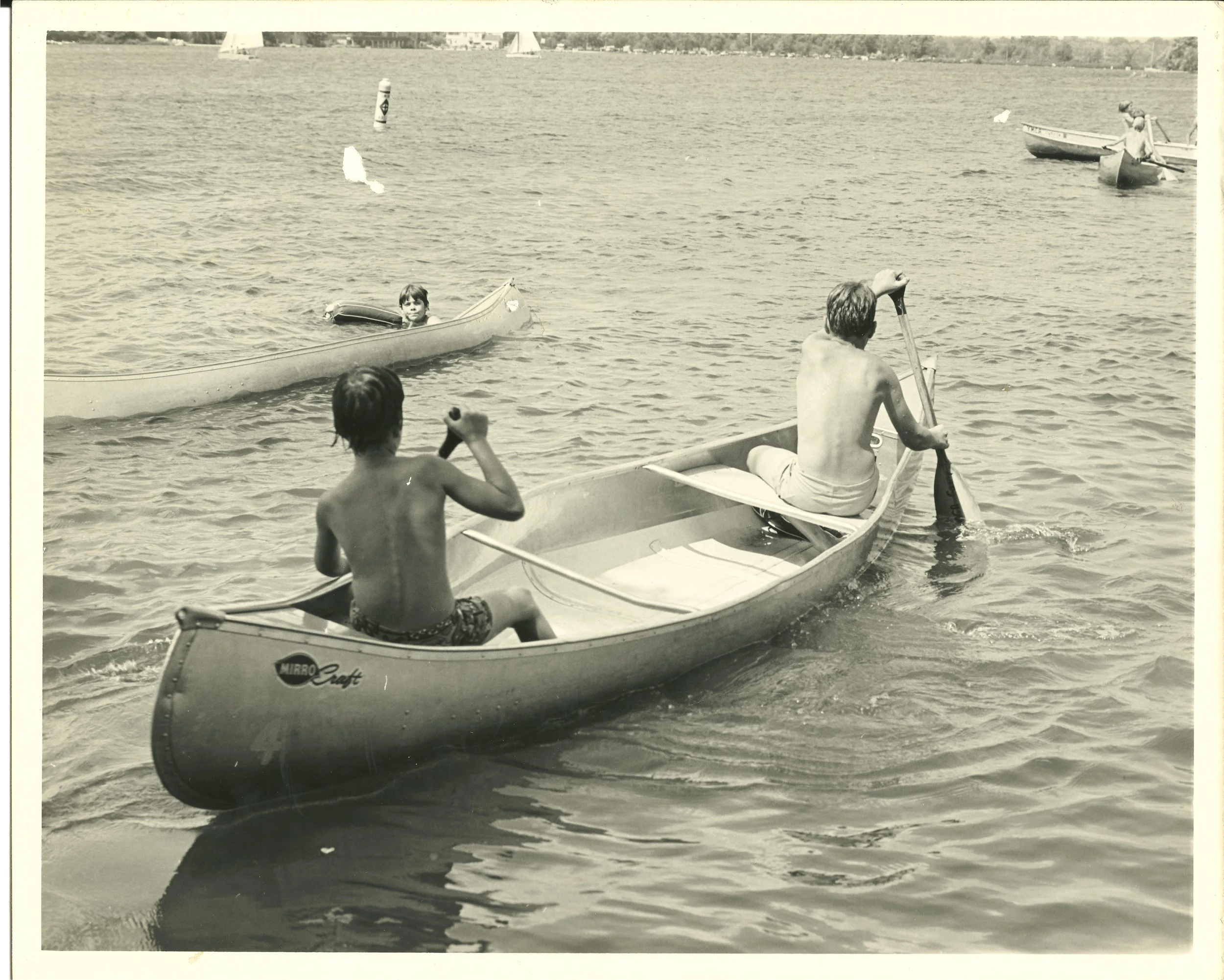 1960s - Campers row their canoe in the lake