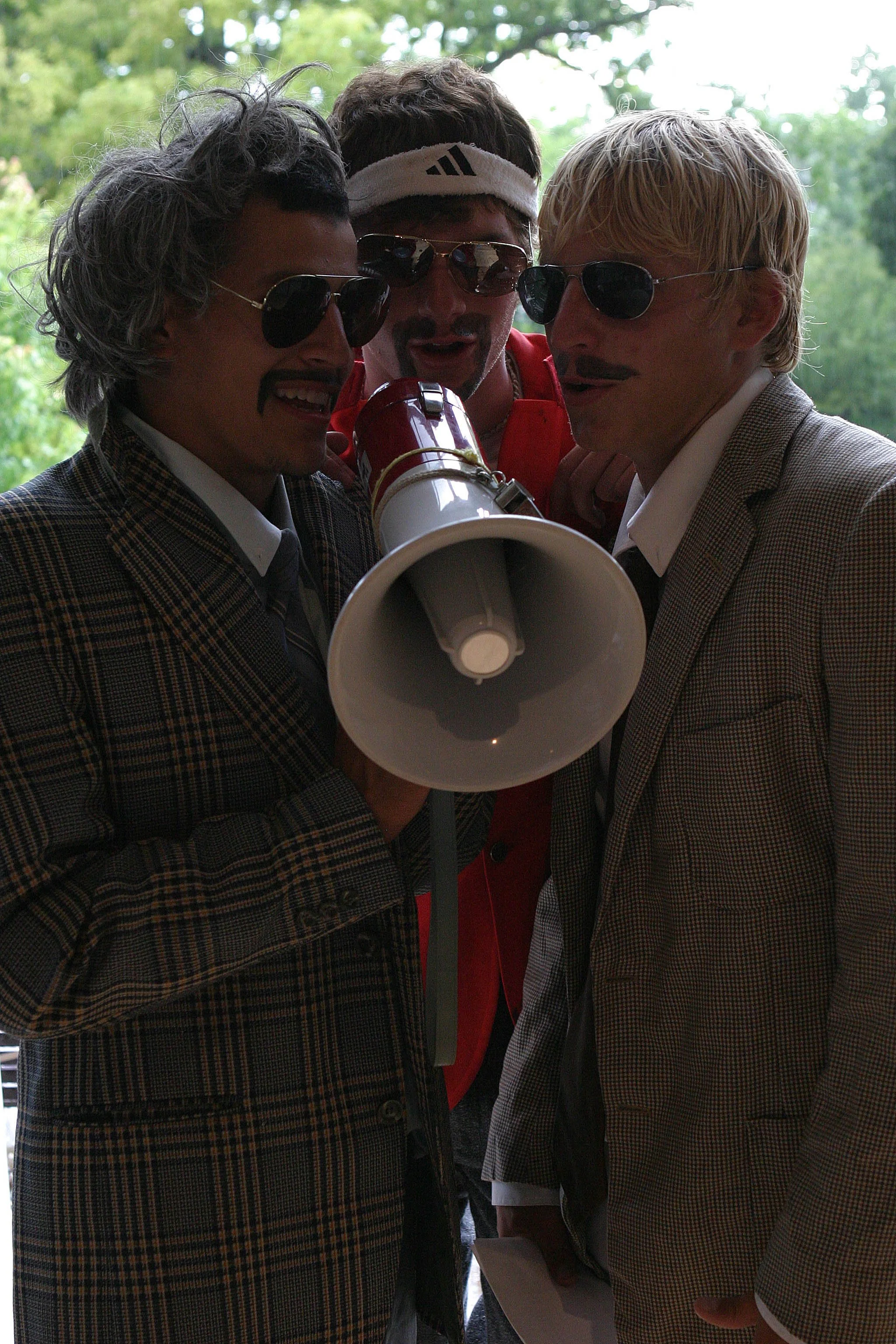 2003 - Tony Ayala, Paul Welch, and Matt Brown in costume with a megaphone
(Pictured: Tony Ayala, Paul Welch, and Matt Brown)